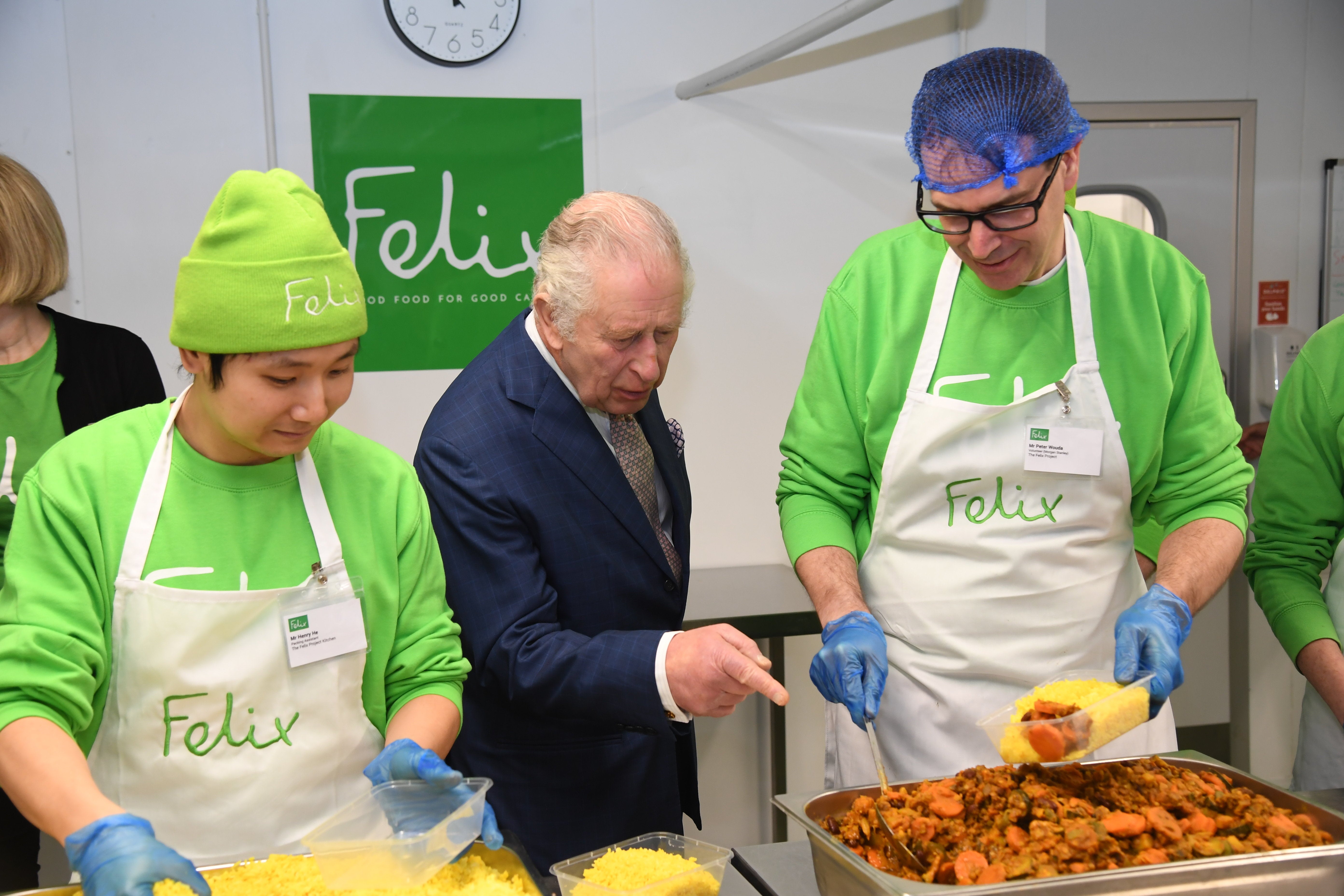 King Charles chats to volunteers as they prepare food at the The Felix Project, which provides meals for vulnerable people in London