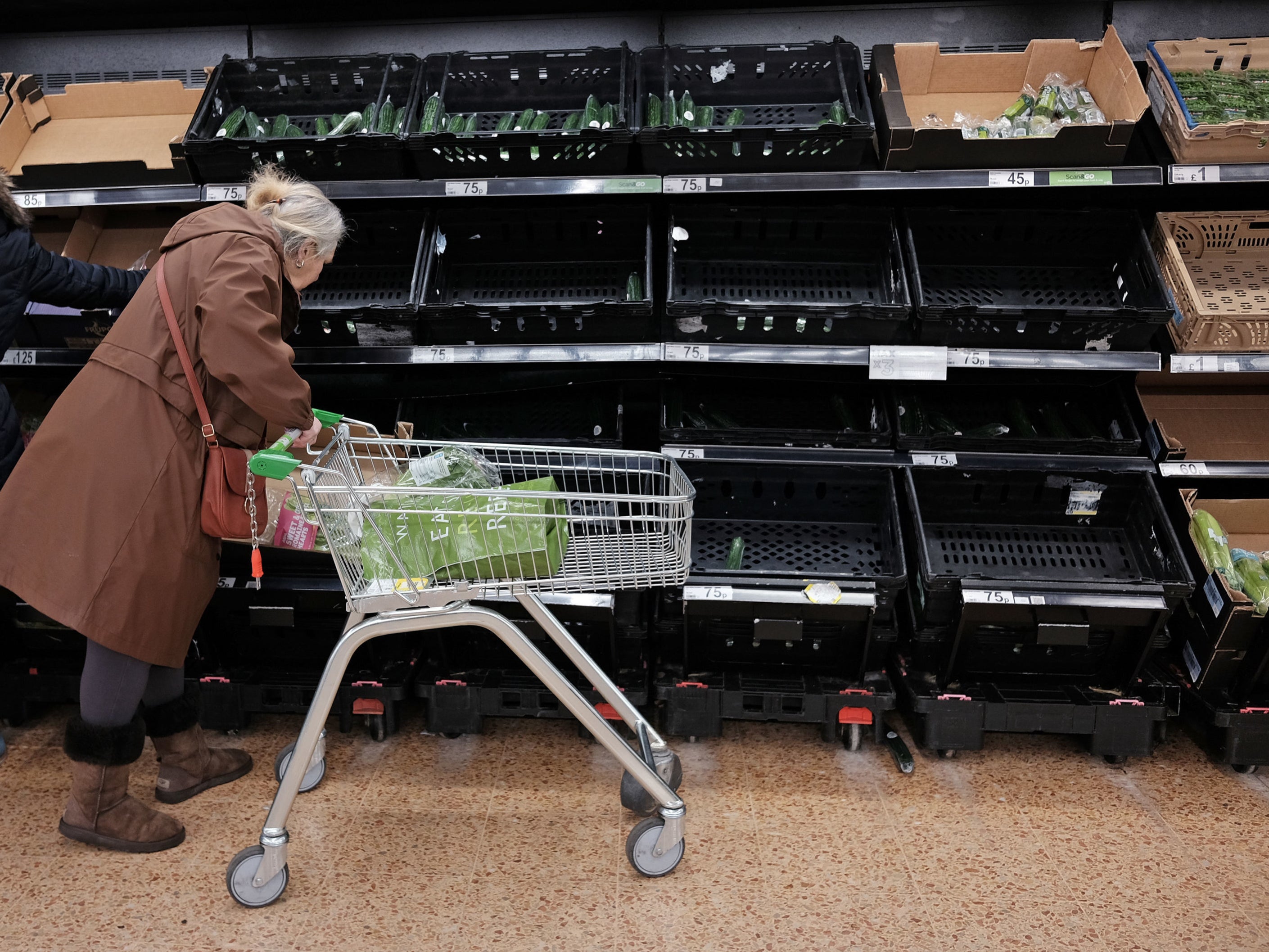 Empty fruit and vegetable shelves at an Asda in east London