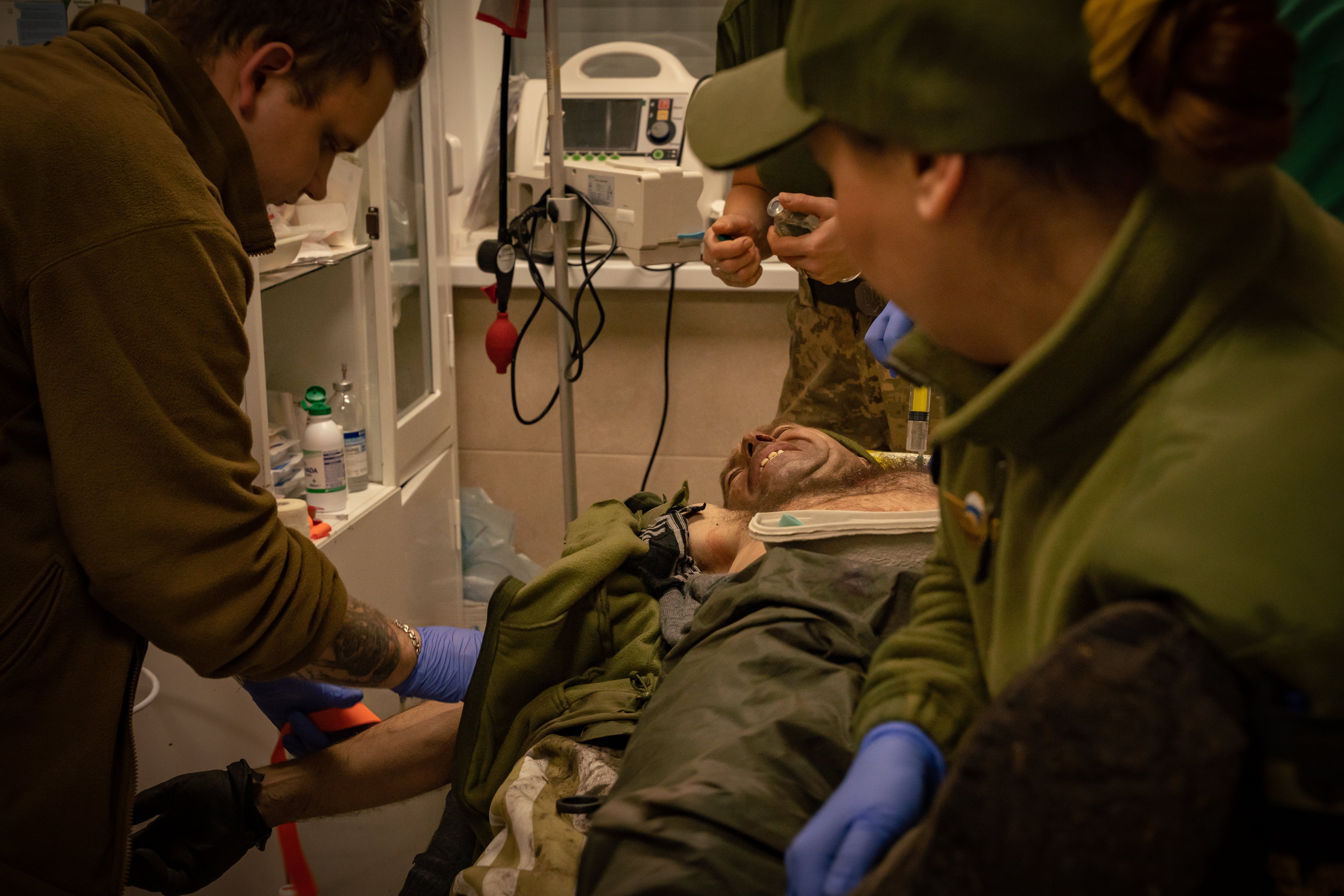 A soldier injured in Soledar cries out in pain a field hospital on the frontline (October)