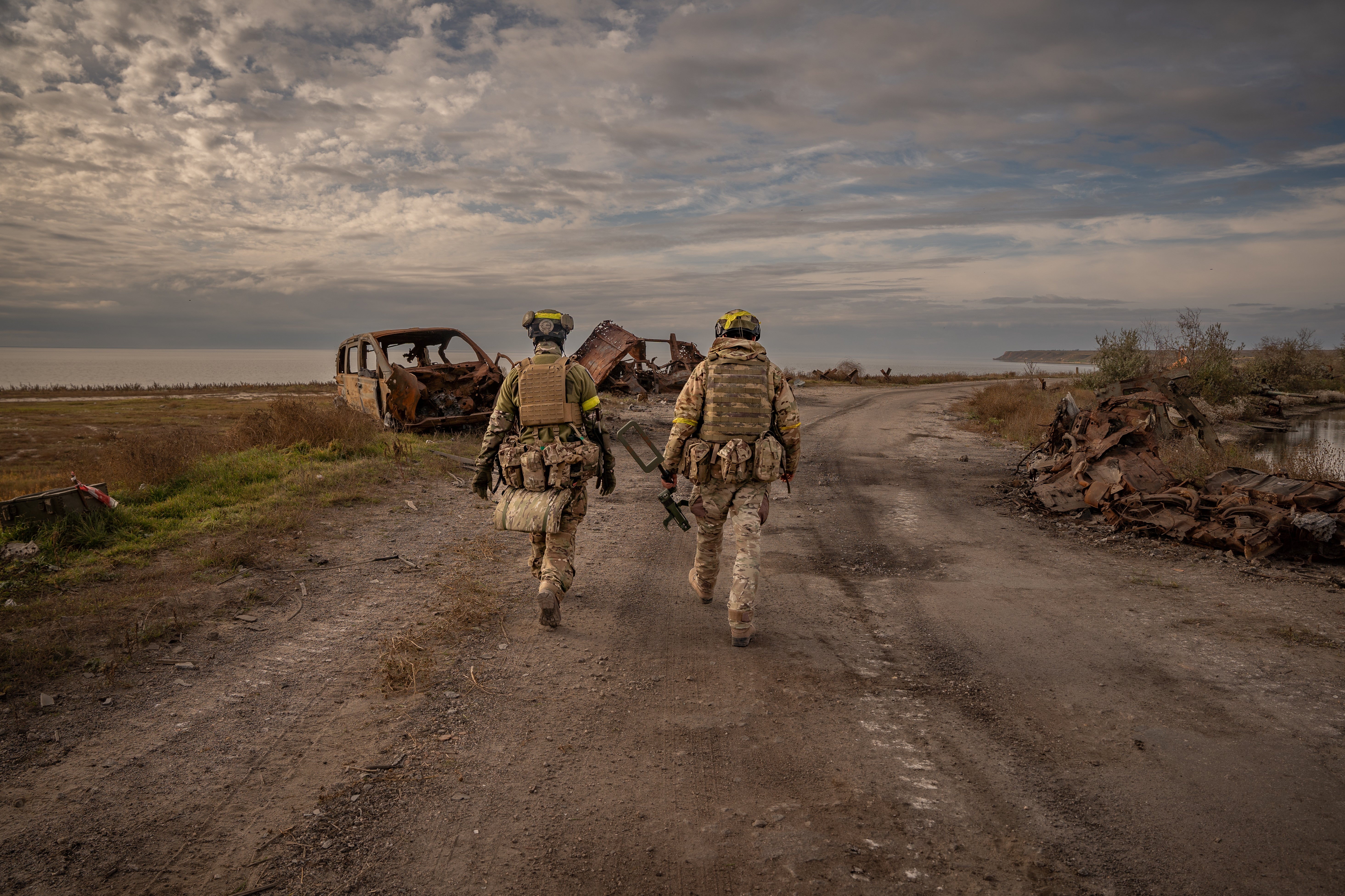 De-miners work on a newly liberated road in Kherson which was held by Russians for month (November)