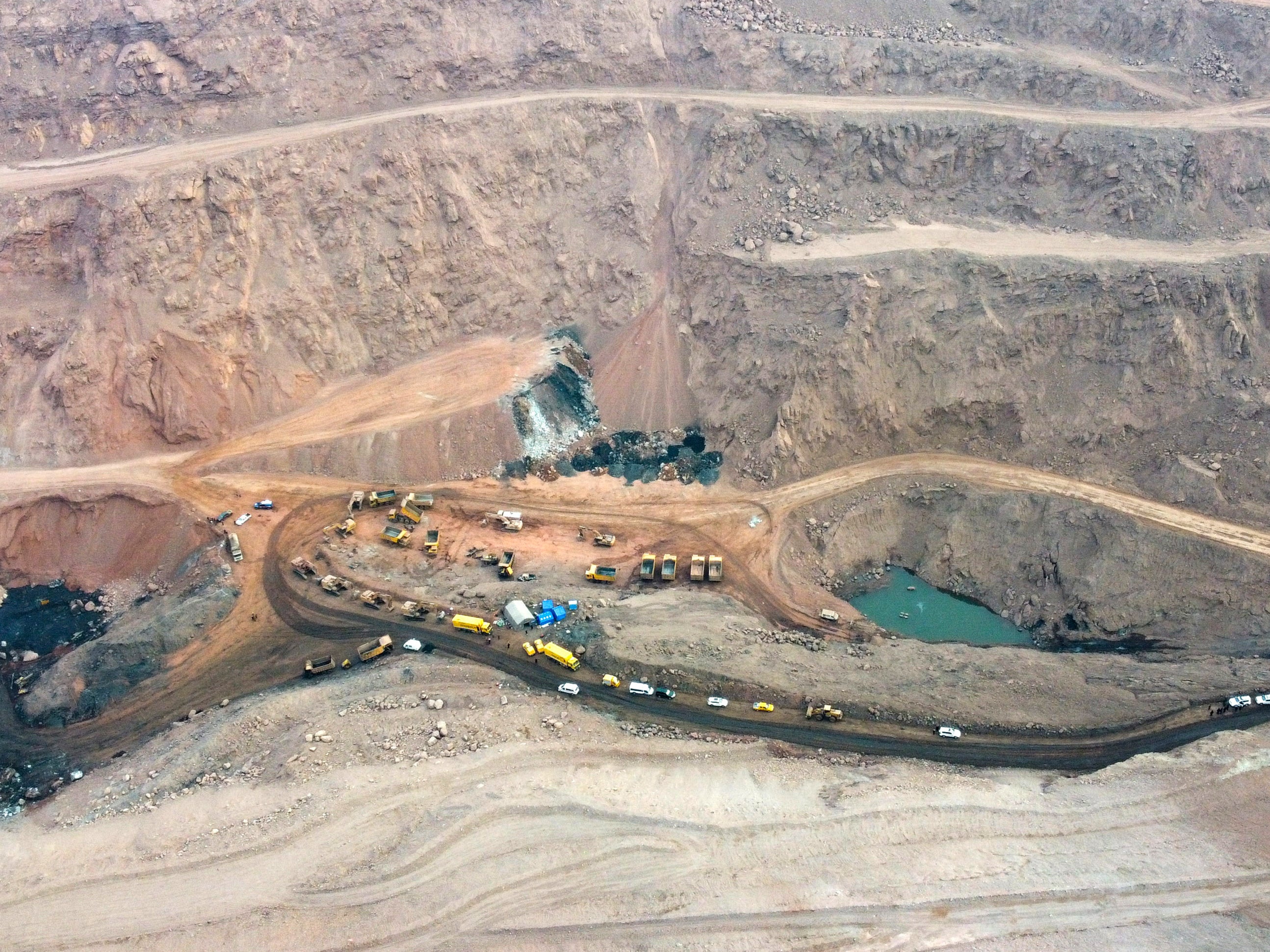 Rescuers work at the site of a collapsed open pit coal mine in Alxa League in northern China