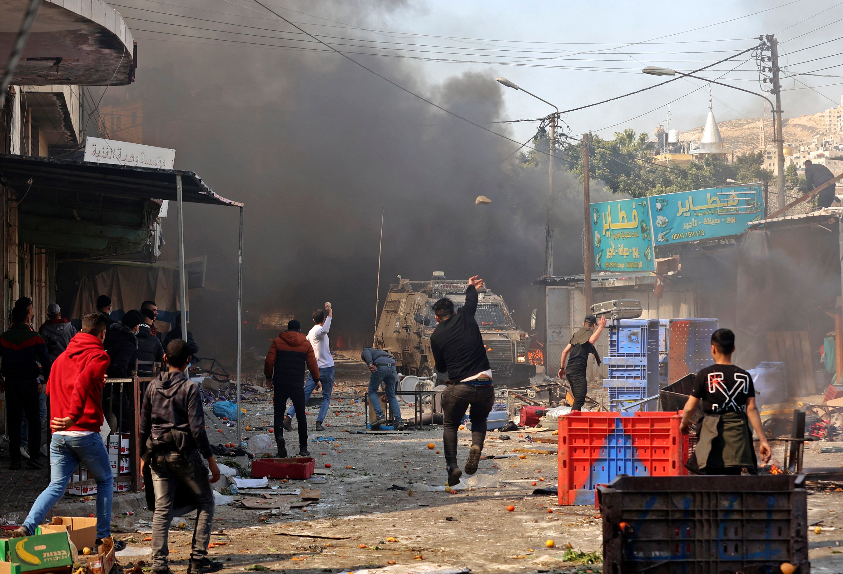 Palestinians clash with Israeli security forces during a raid in the occupied West Bank city of Nablus