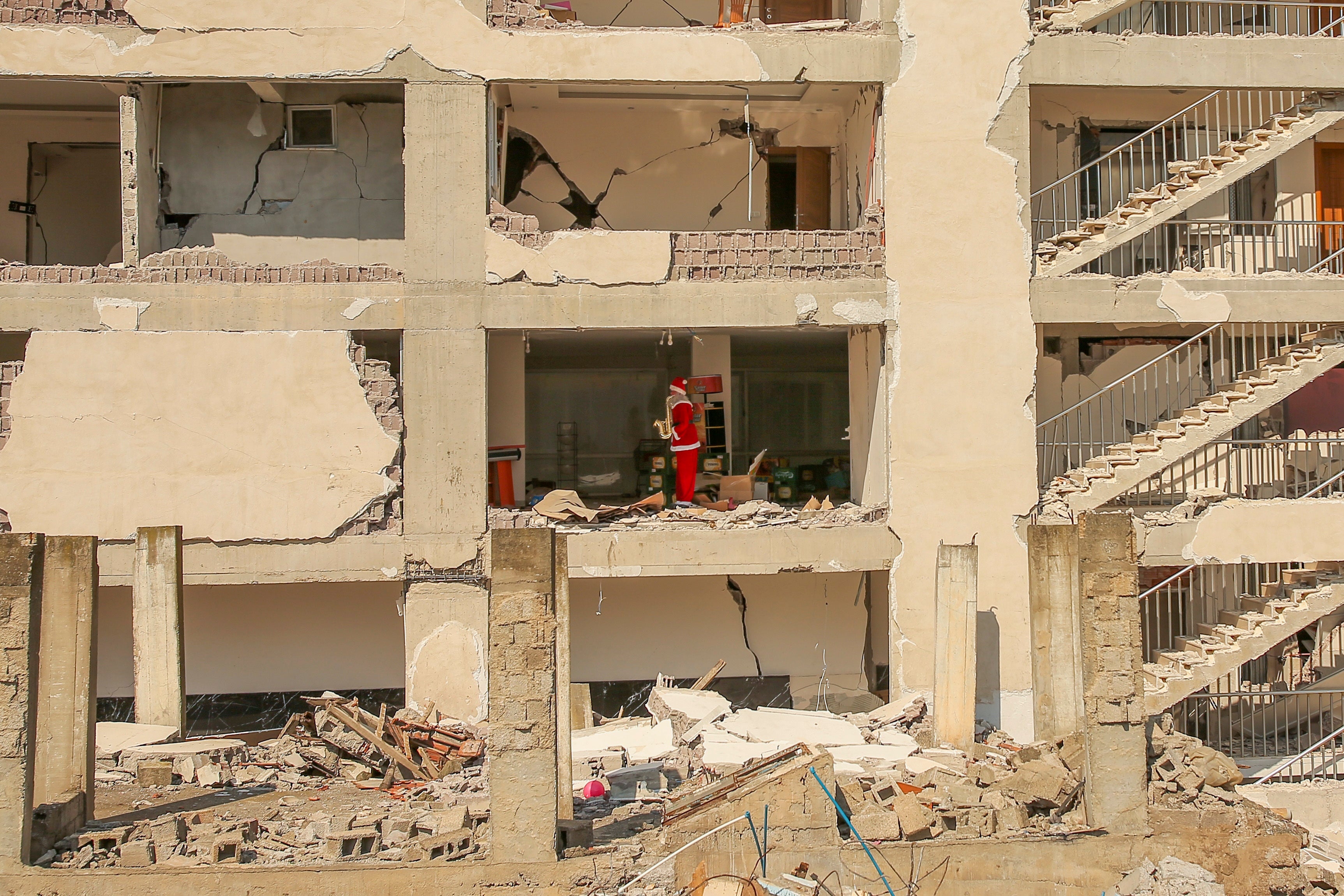 A mannequin dressed as Santa Claus stands inside an apartment of a destroyed building following the earthquake in Samandag