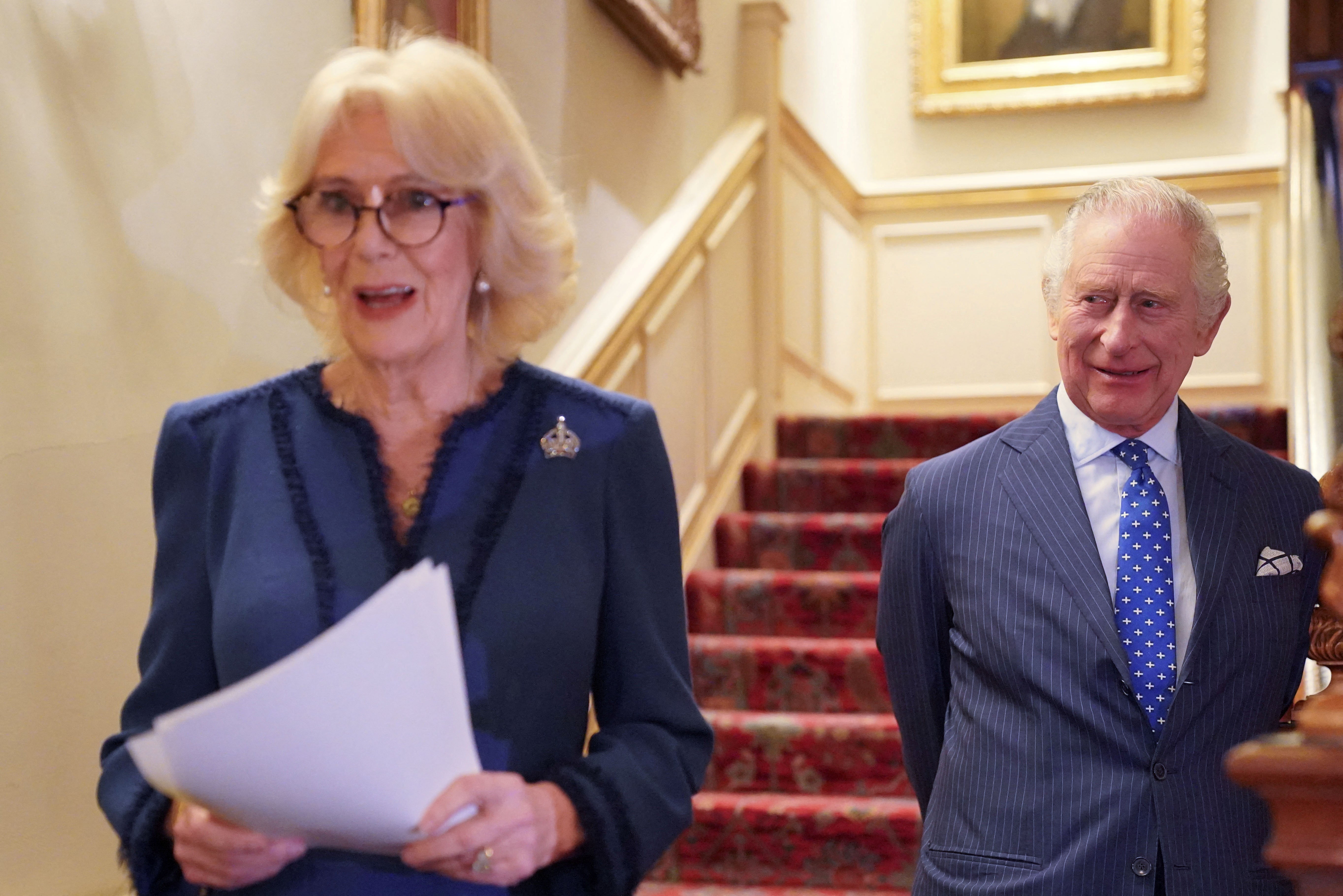 The Queen Consort, joined by King Charles III, hosts a reception at Clarence House on the anniversary of the Reading Room