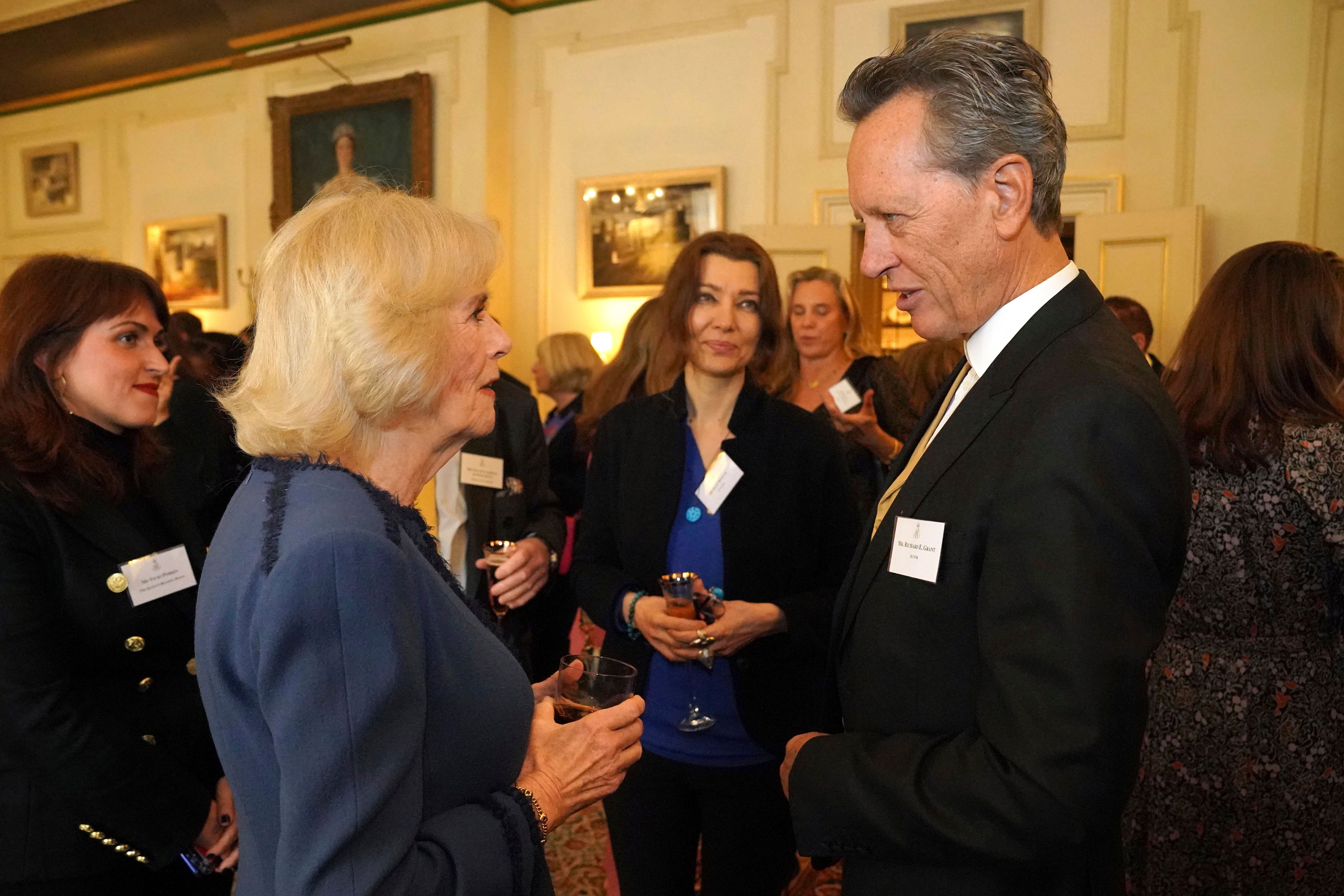 Camilla speaks to Richard E Grant at the Clarence House reception