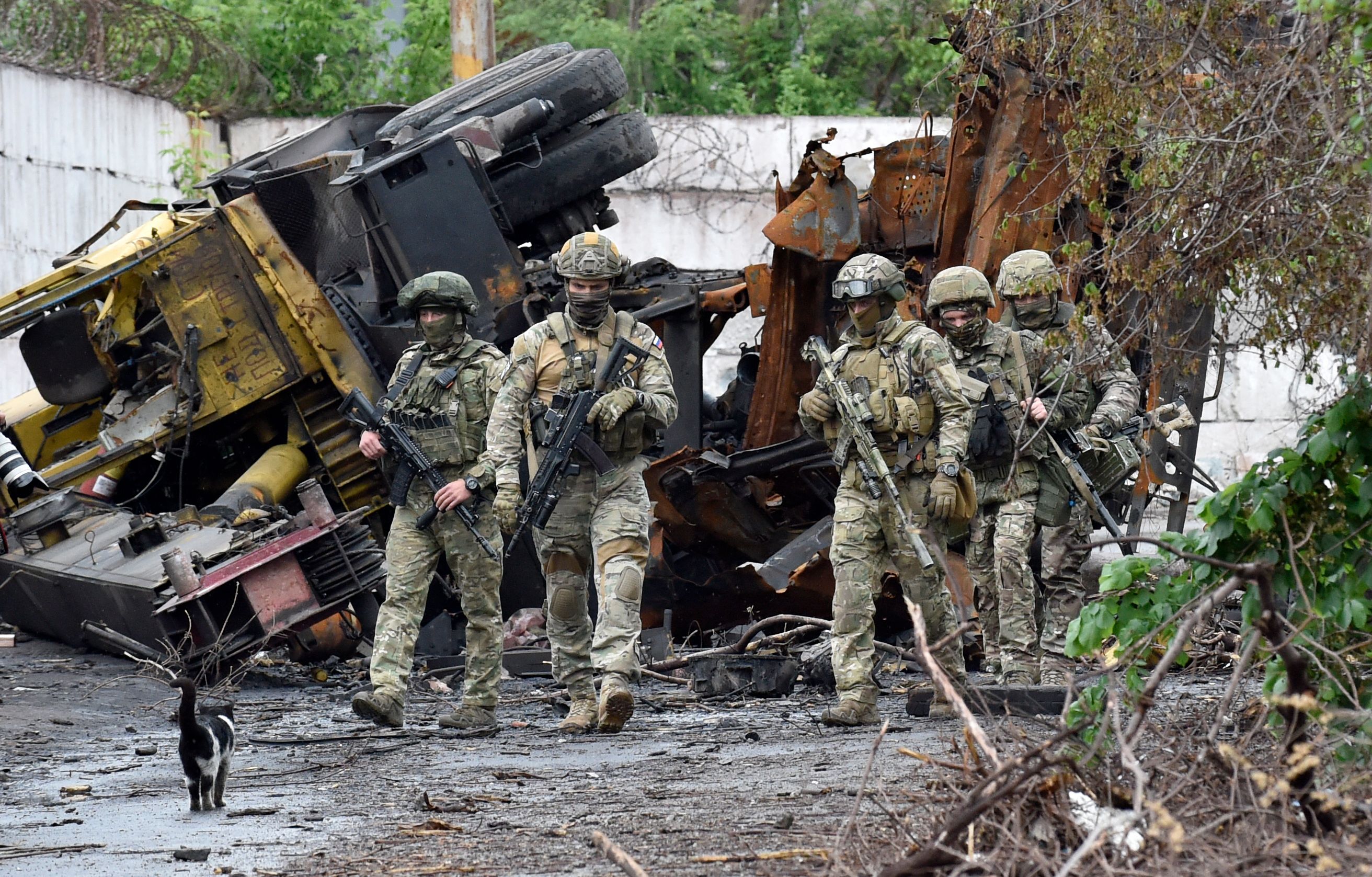 Russian servicemen patrol the destroyed part of the steel works in Ukraine's port city of Mariupol