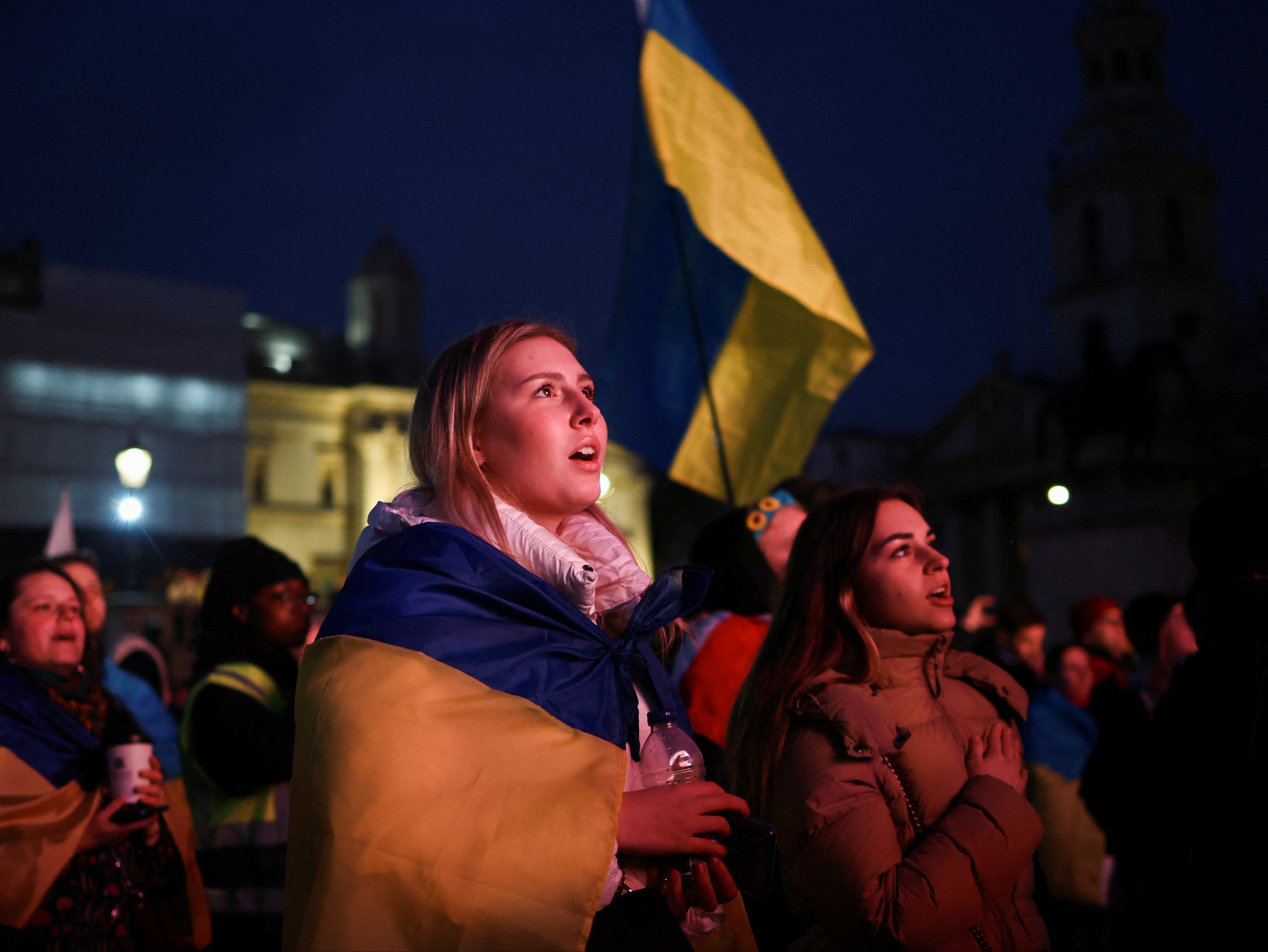 People attend a vigil for Ukraine held on the anniversary of the conflict with Russia, at Trafalgar Square in London