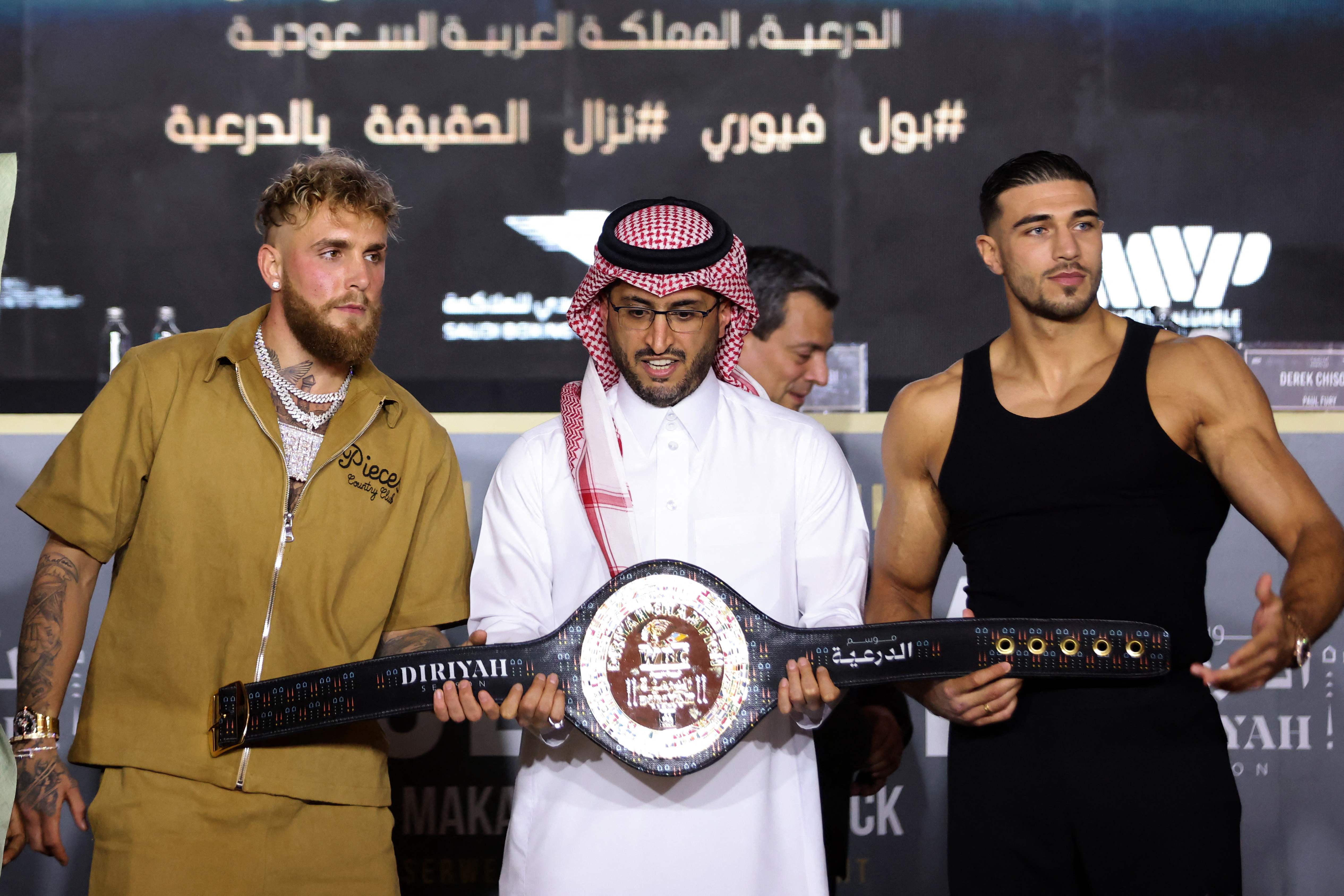 Jake Paul and Tommy Fury pose for a picture with the belt