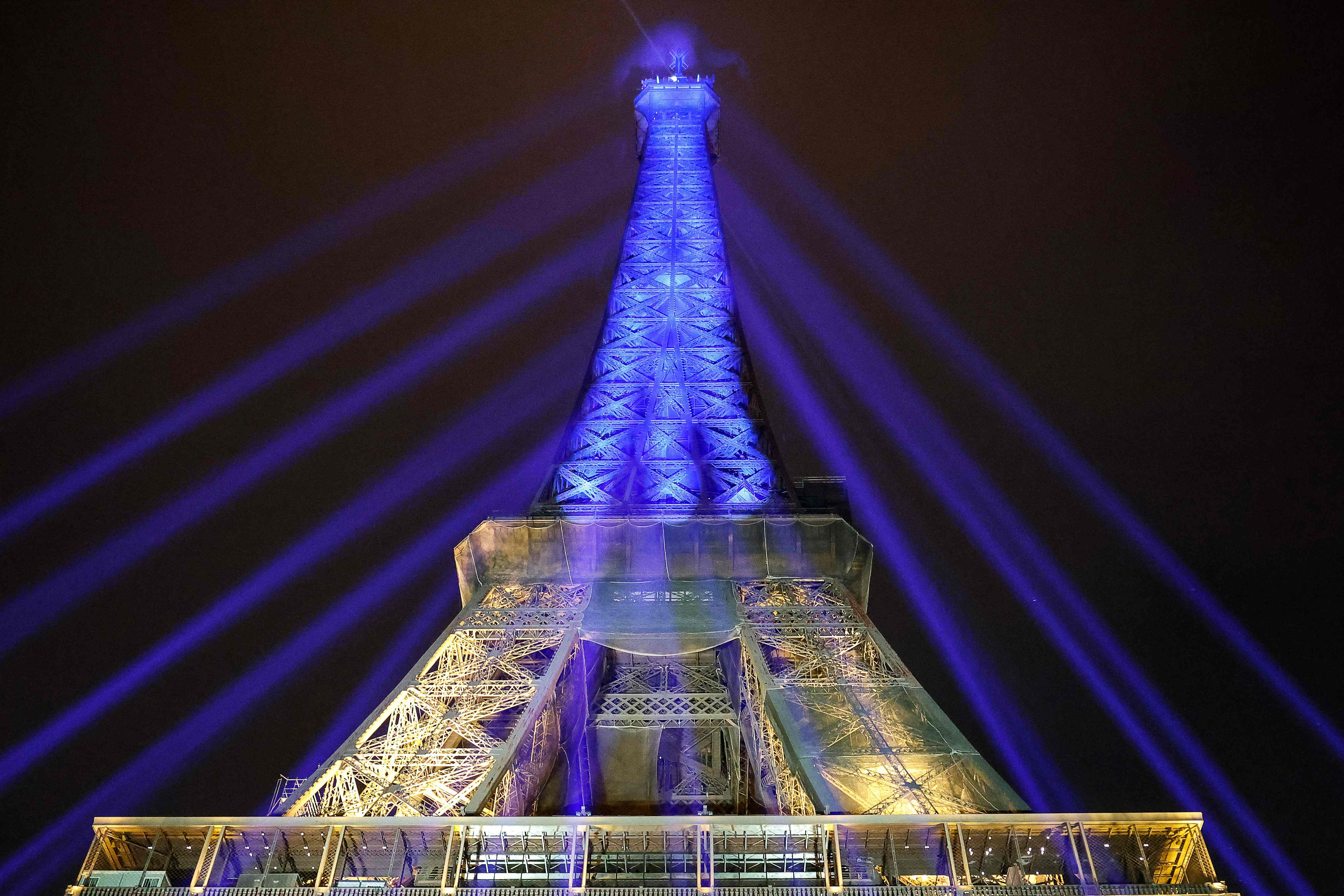 A photo shows the Eiffel Tower lit in the colours of the Ukrainnian flag in a show of support to Ukraine