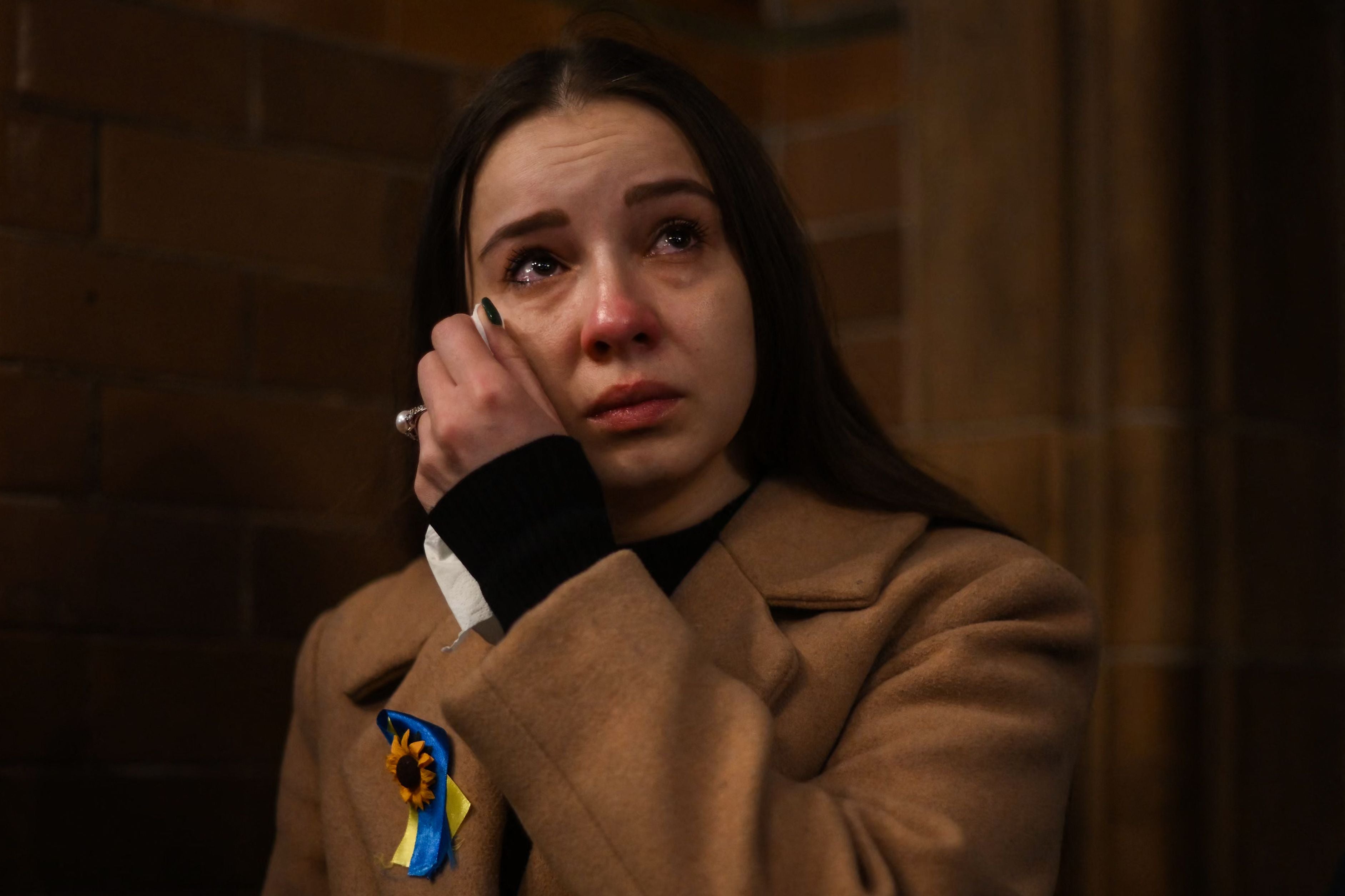 A woman dries her tears during the ecumenical prayer service at Ukrainian Catholic Cathedral, in London