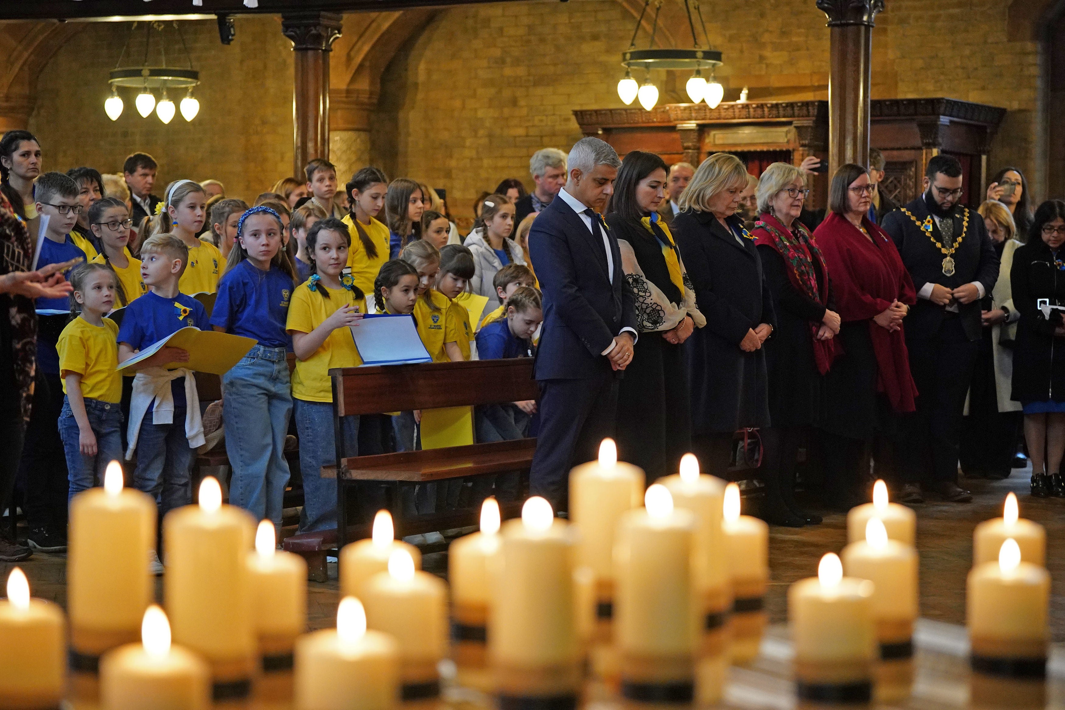 Mayor of London Sadiq Khan and members of the congregation observe a minute's silence