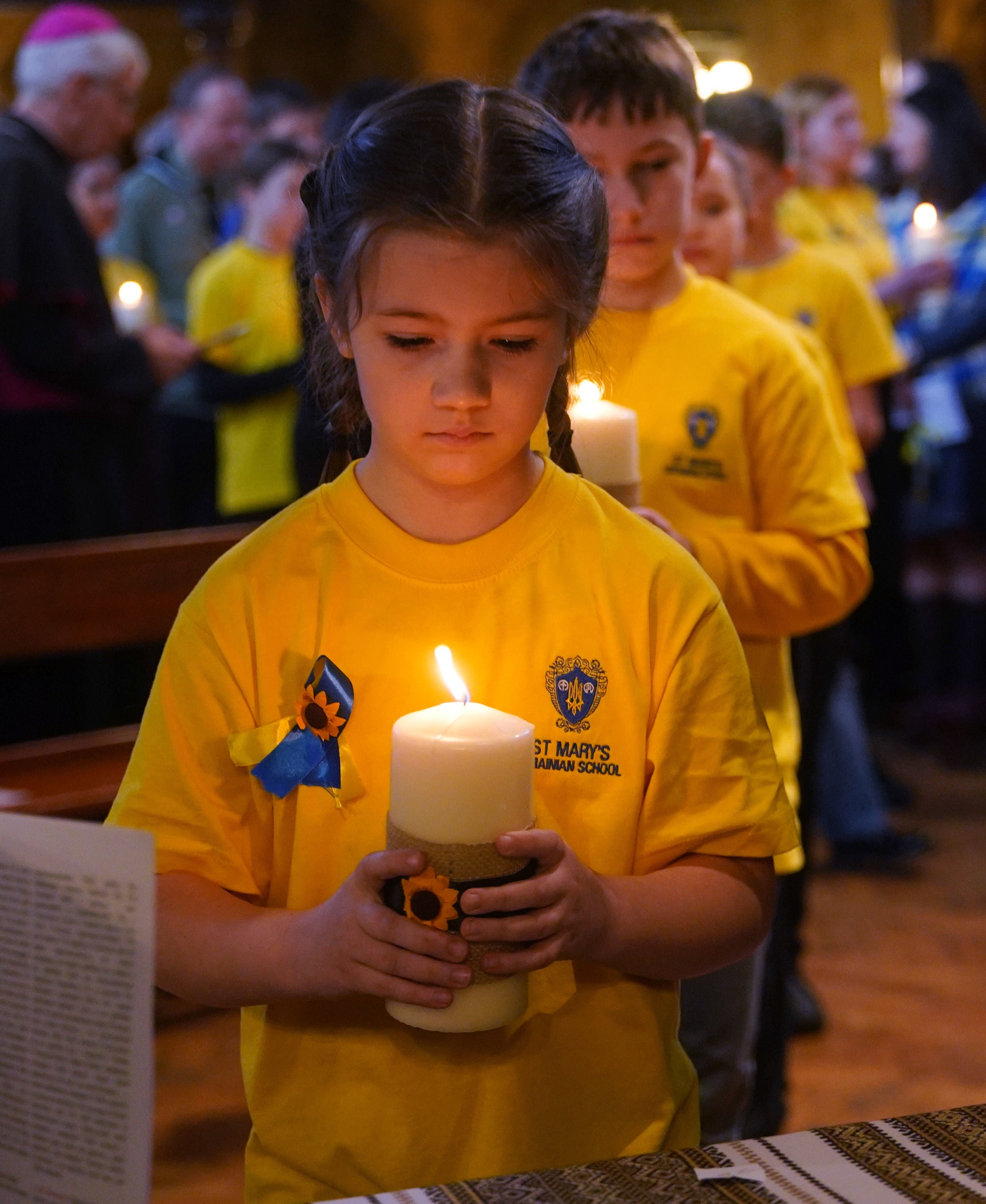 Children from St Mary’s Ukrainian School lighting 52 candles - one for each week of the war