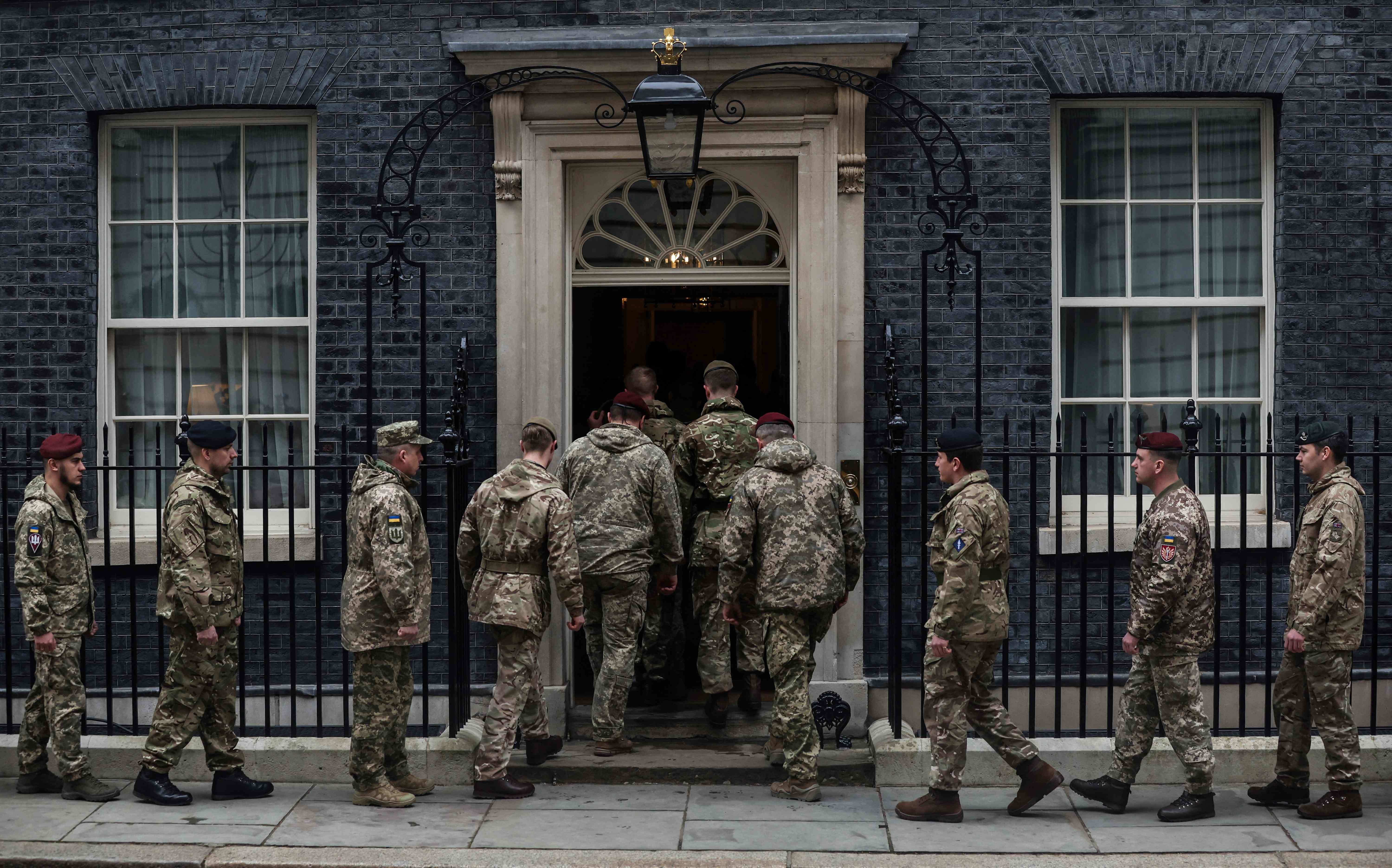 Members of the Ukrainian Armed Forces enter 10 Downing Street, in London, after the National one minutes silence to mark one year since the invasion of Ukraine by Russia