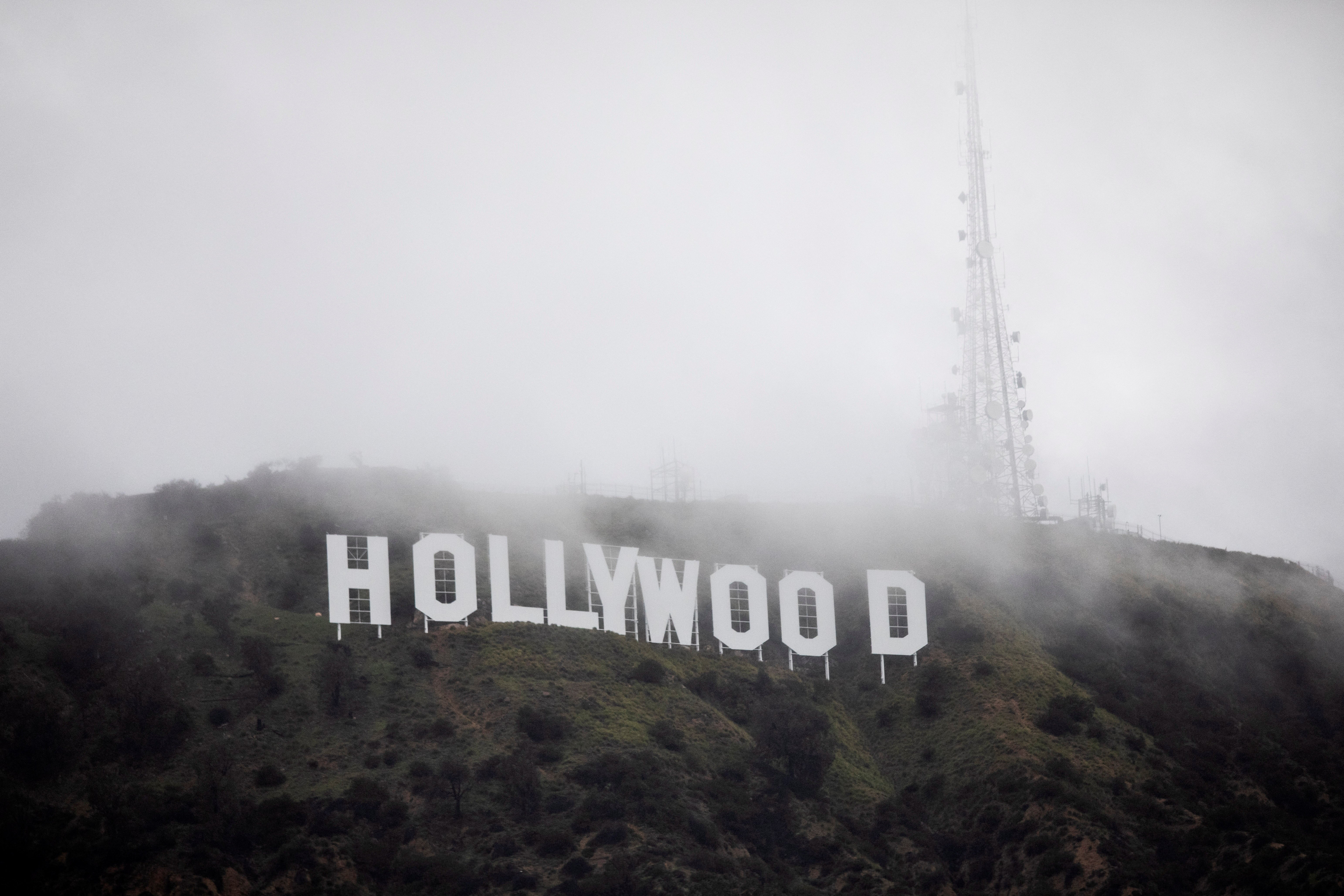 The Hollywood sign is seen through a mix of fog and dust snow during a rare cold winter storm