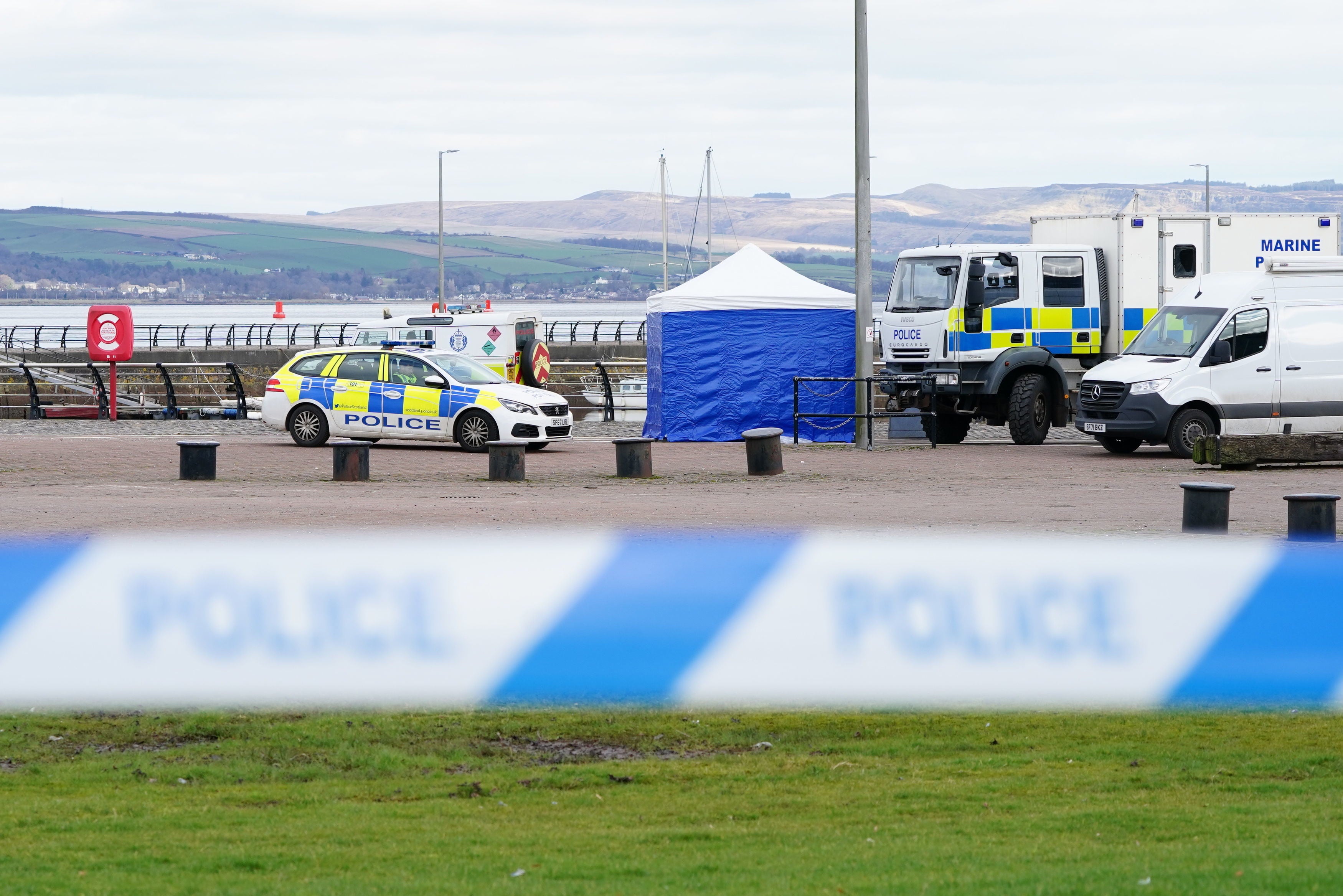 A police tent is erected quayside after a tugboat sank at the Custom House Quay