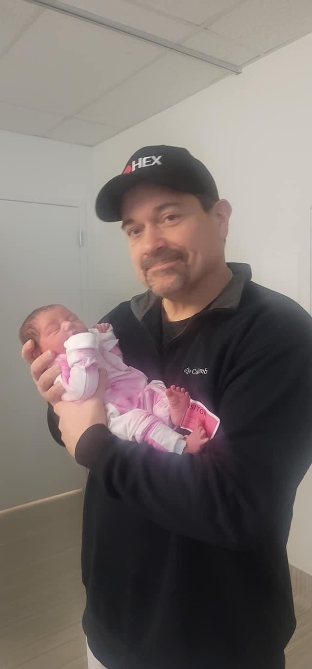 Steve Goncalves, father of Idaho college murder victim Kaylee Goncalves, poses with his new granddaughter named for the student and her best friend, Madison Mogen