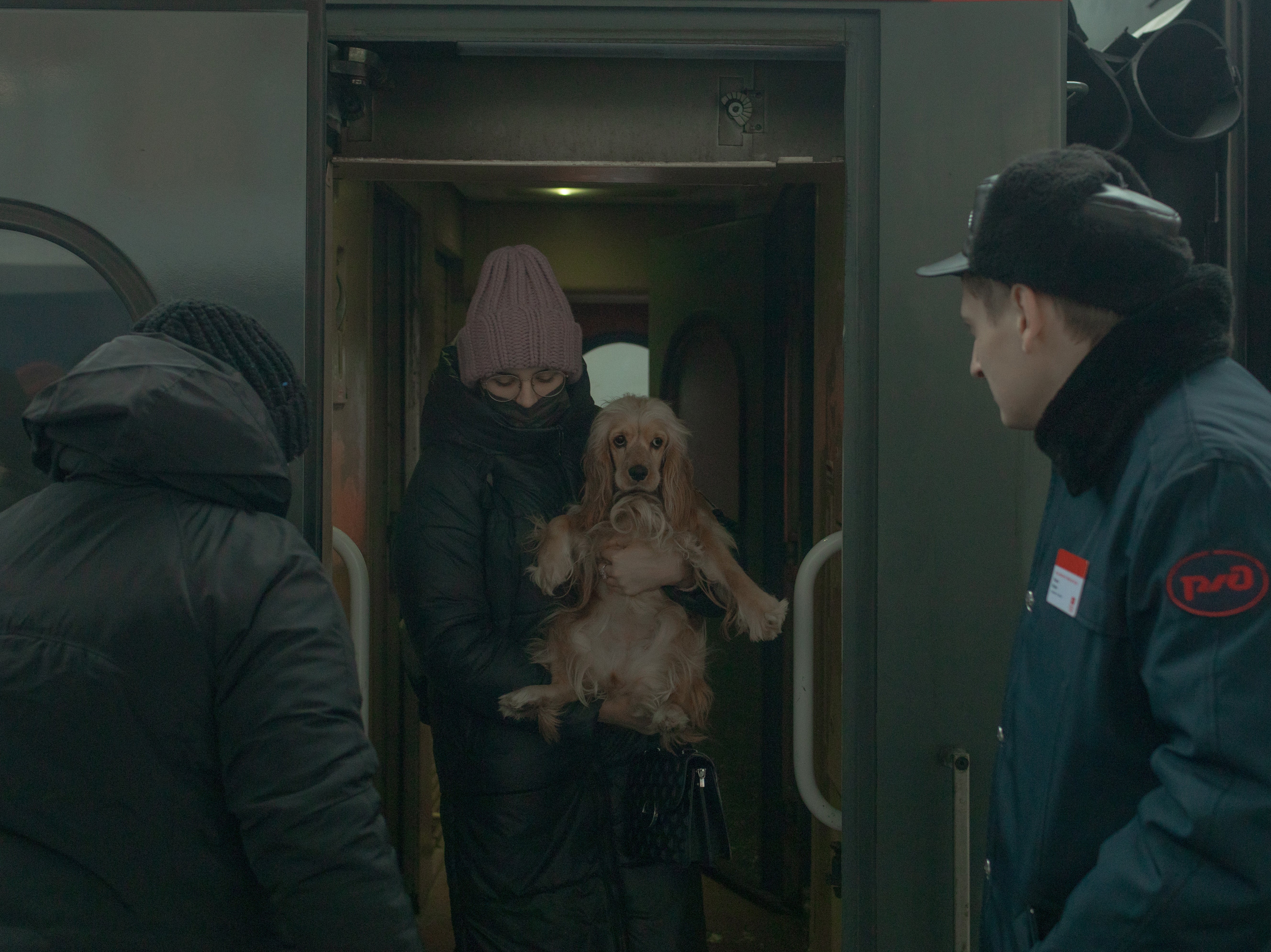 A young Ukrainian refugee disembarks from the train at the Moskovsky railway station in St Petersburg, holding her dog in her arms