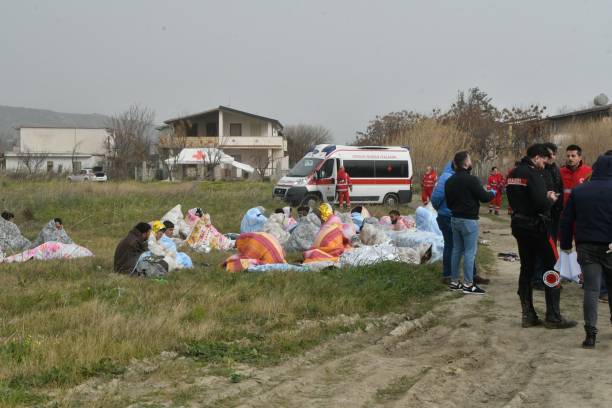 This photo obtained from Italian news agency Ansa, taken on 26 February 2023 shows rescued migrants wrapped in a blanket