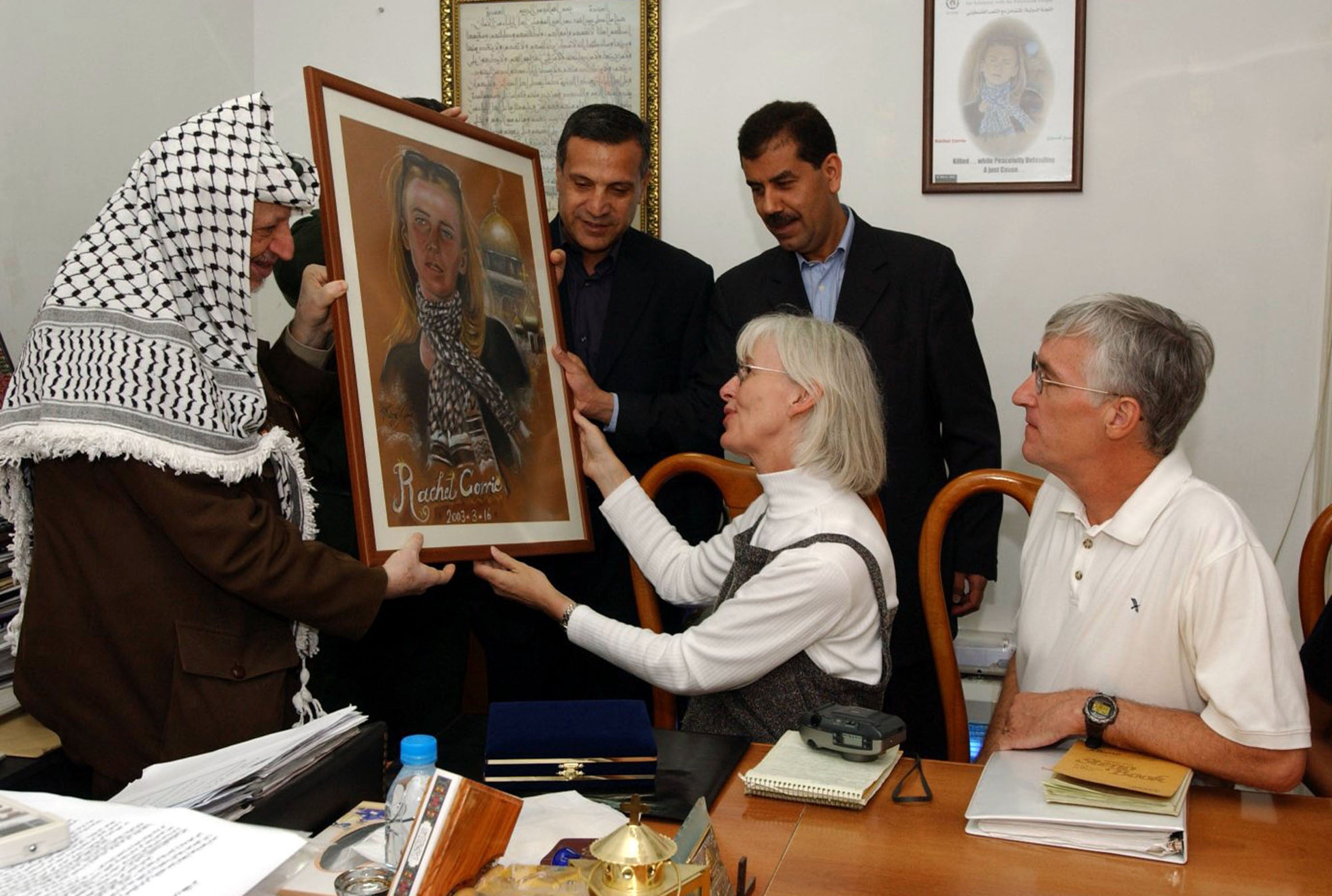 Palestinian leader Yasser Arafat, left, was given a drawing of Corrie by her parents in the West Bank town of Ramallah in September 2003