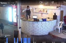 Waitress jumps over counter in panic as 13ft cobra slithers into bar