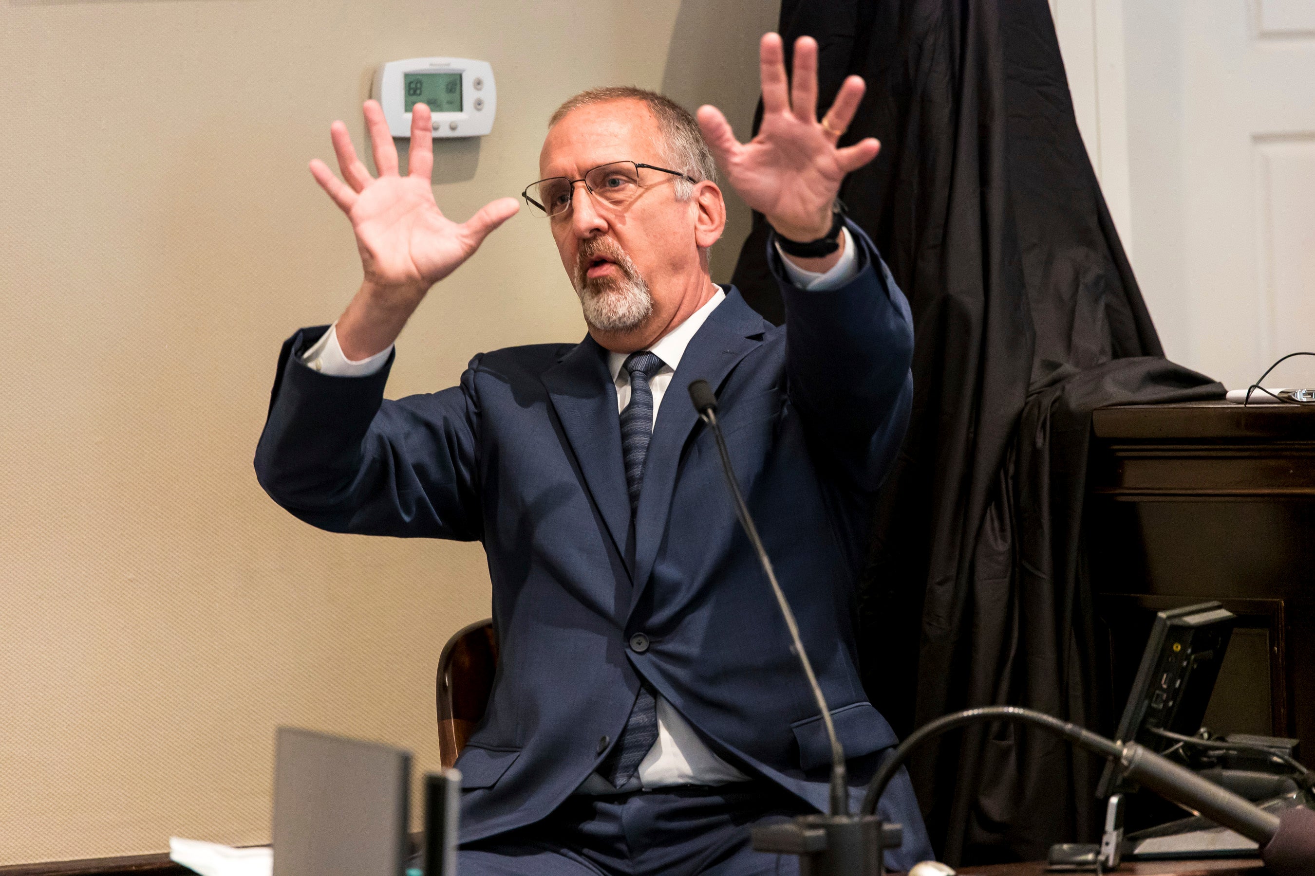 Tim Palmbach, a forensic scientist, demonstrates the affect of a shotgun blast