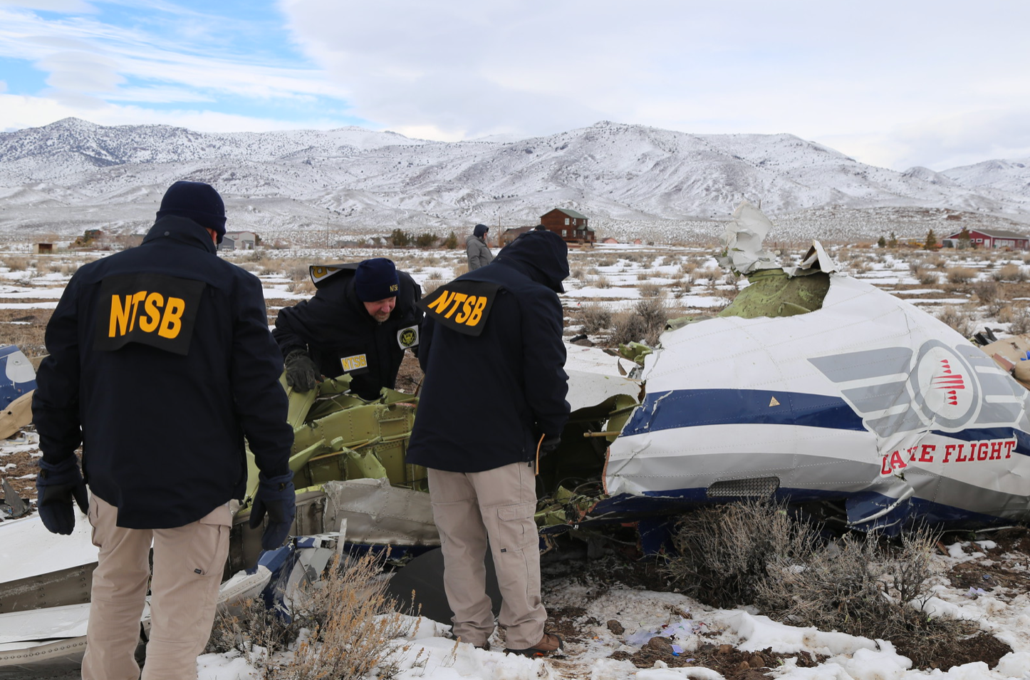 Investigators at a crash scene after a Care Flight medical transport plane crashed near Stagecoach, Nevada, killing all five on board