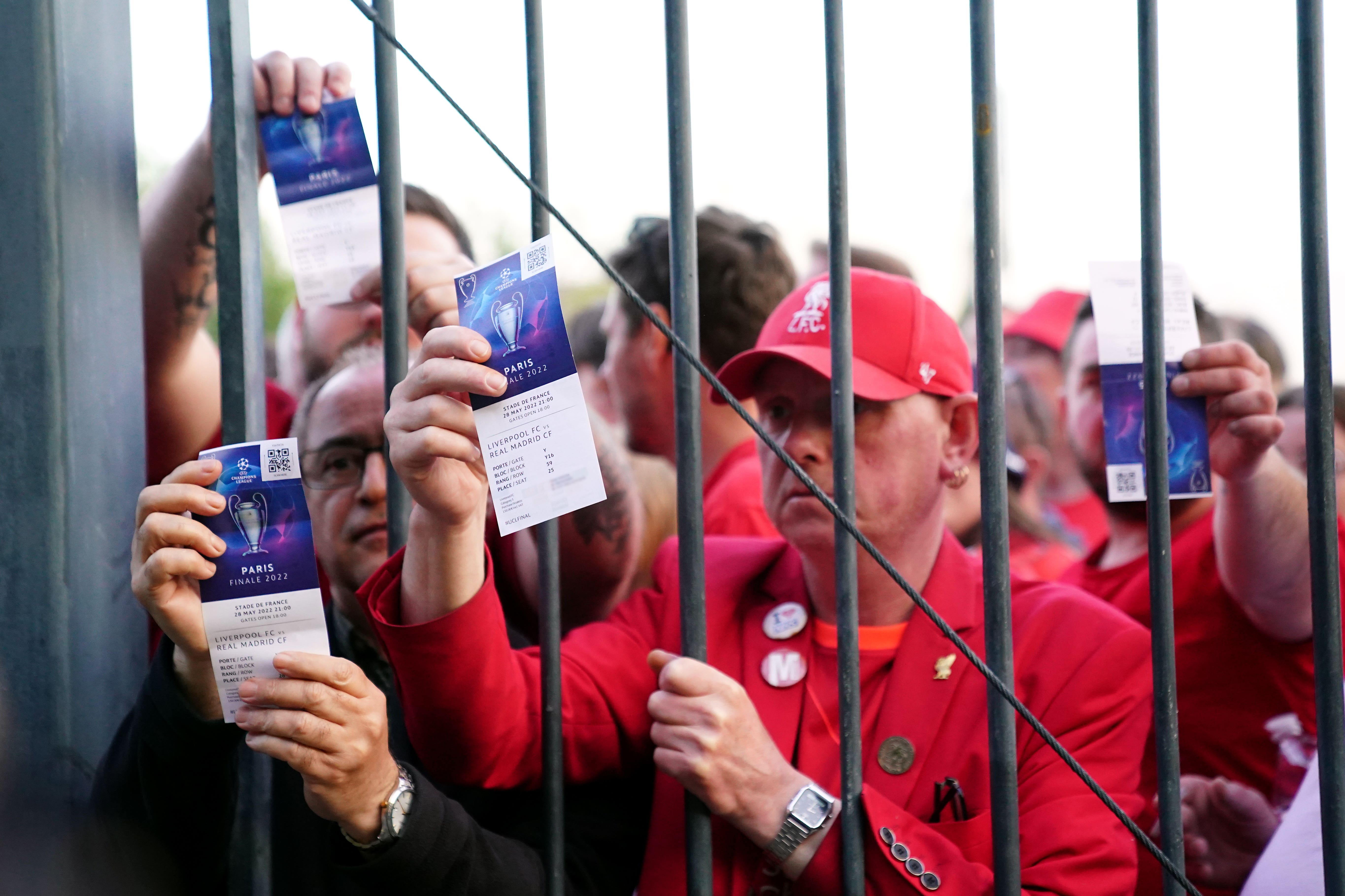 Liverpool fans stuck outside the Stade de France show their match tickets ahead of last season’s Champions League final (Adam Davy/PA)