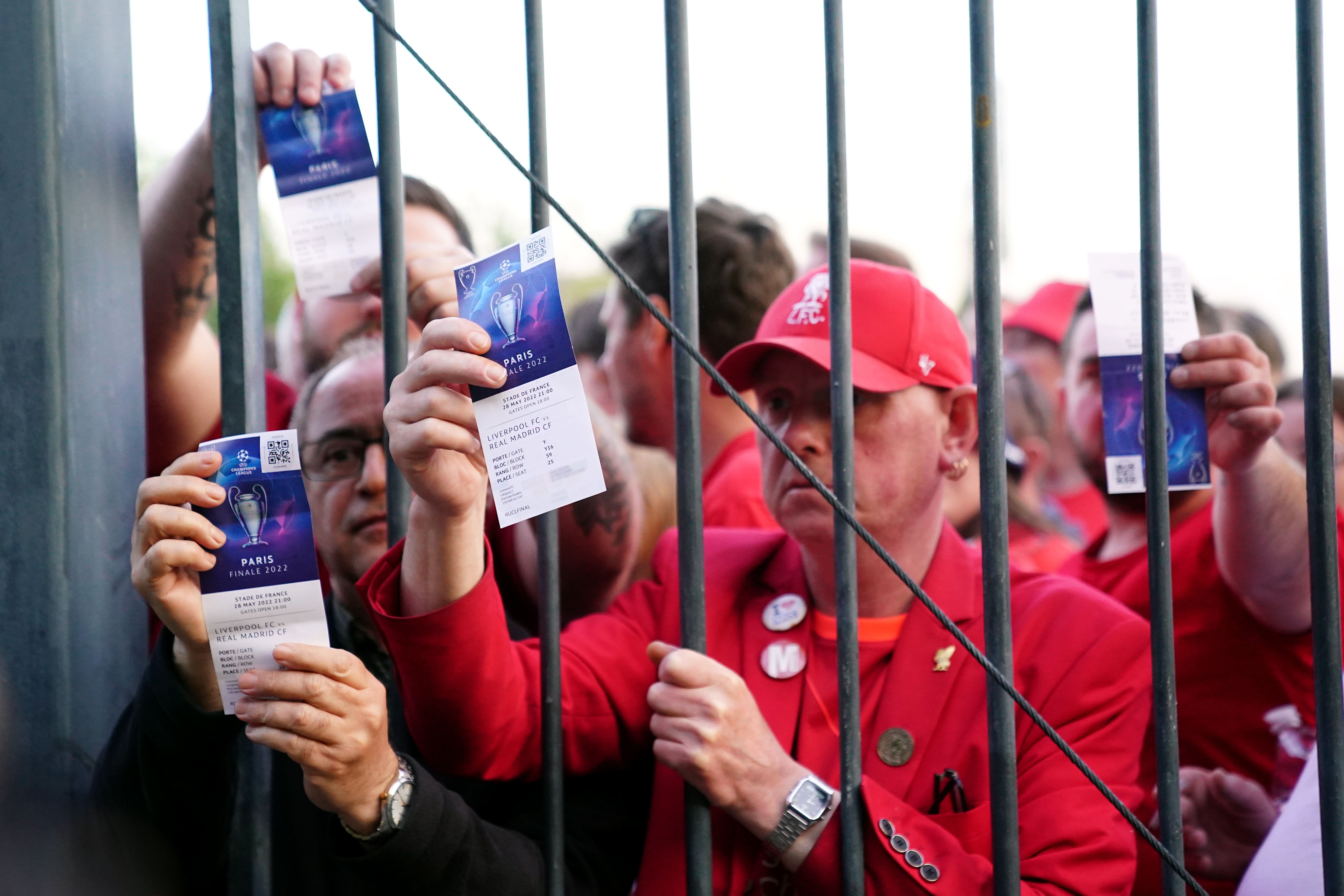 Liverpool fans stuck outside the ground show their match tickets (Adam Davy/PA)