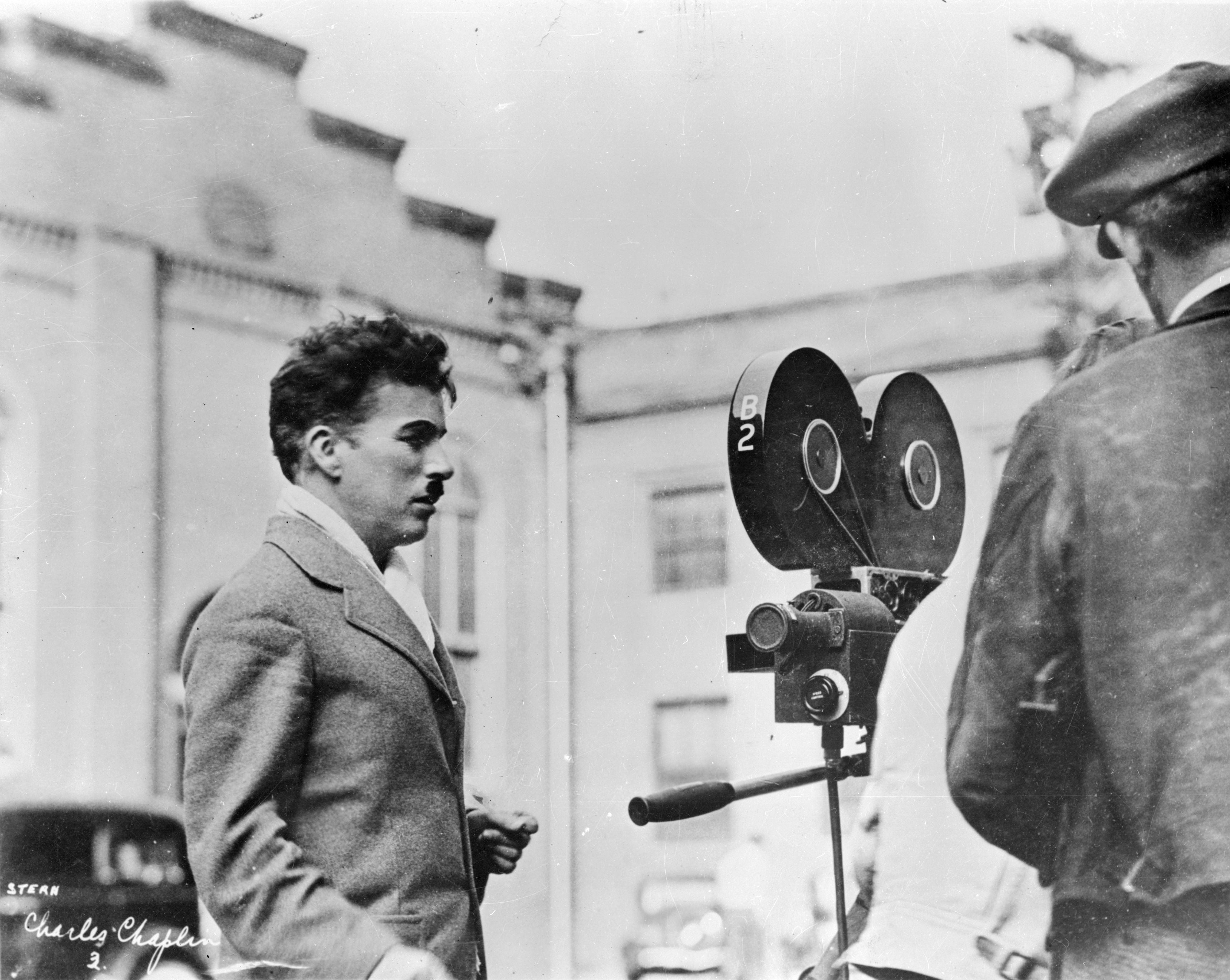 Charlie Chaplin looking at a movie camera