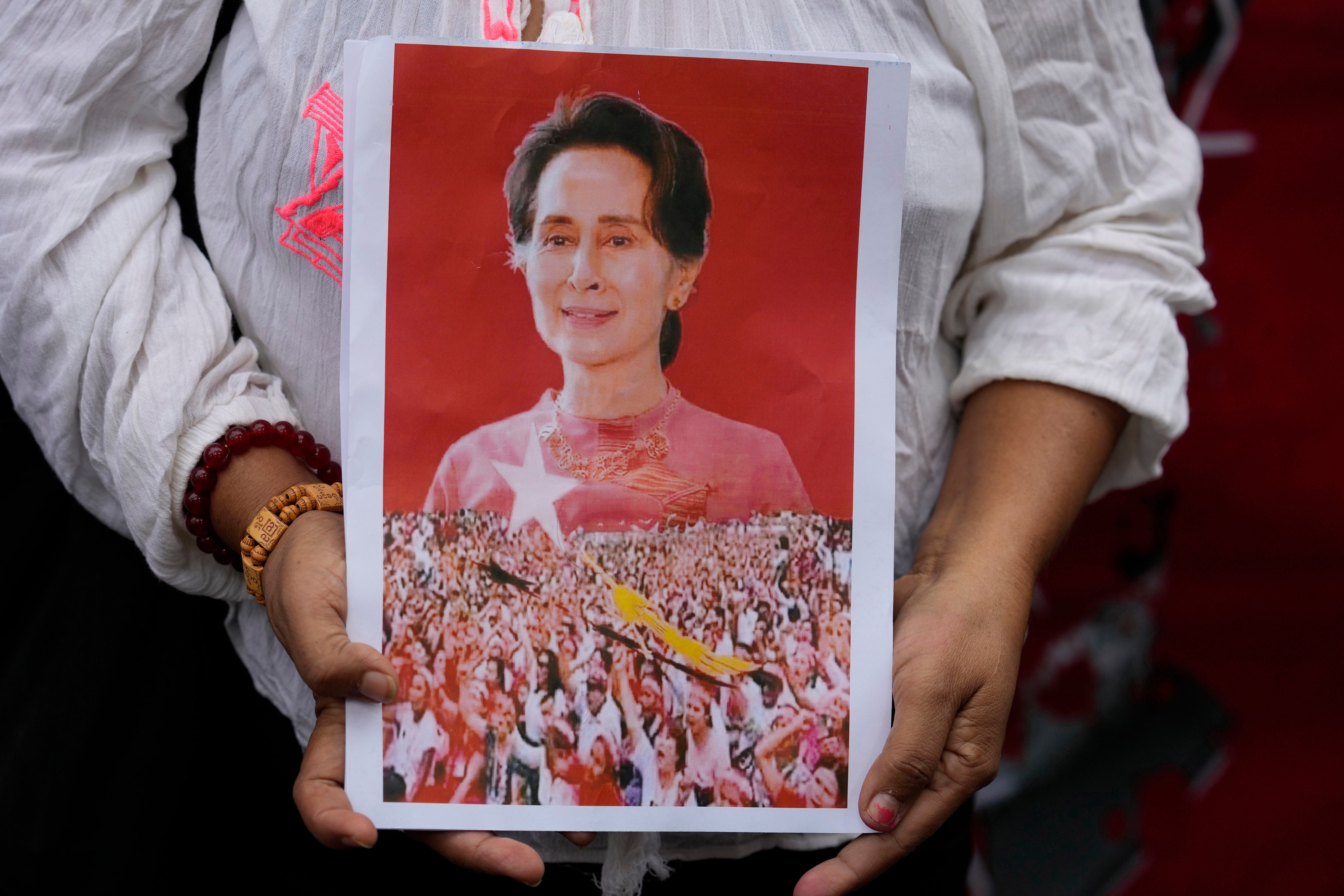 A supporter shows a portrait of former leader Aung San Suu Kyi