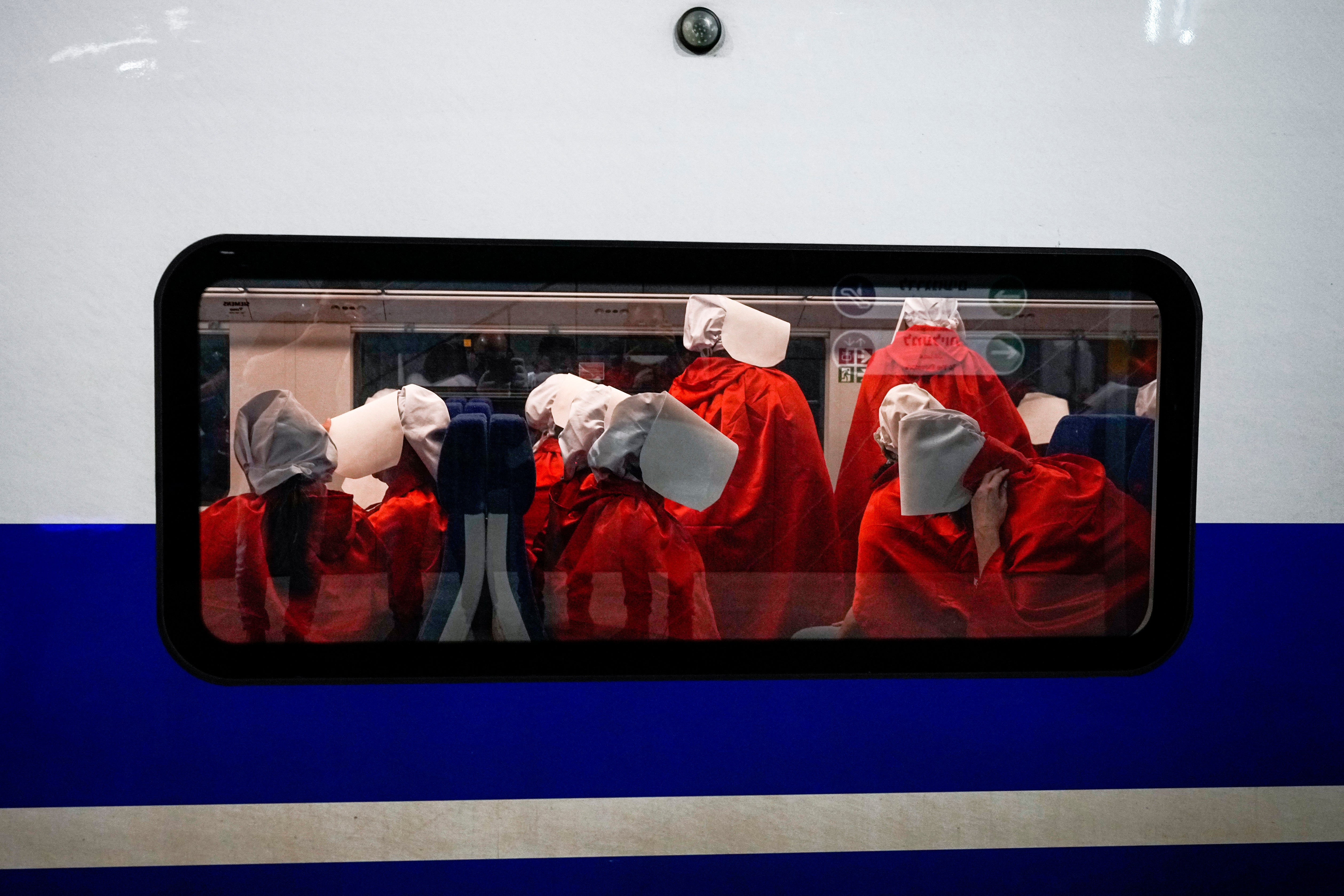 Protesters supporting women’s rights dressed as characters from The Handmaid’s Tale TV series traveling to a protest against plans by Prime Minister Benjamin Netanyahu’s new government to overhaul the judicial system, at a railway station in Jerusalem