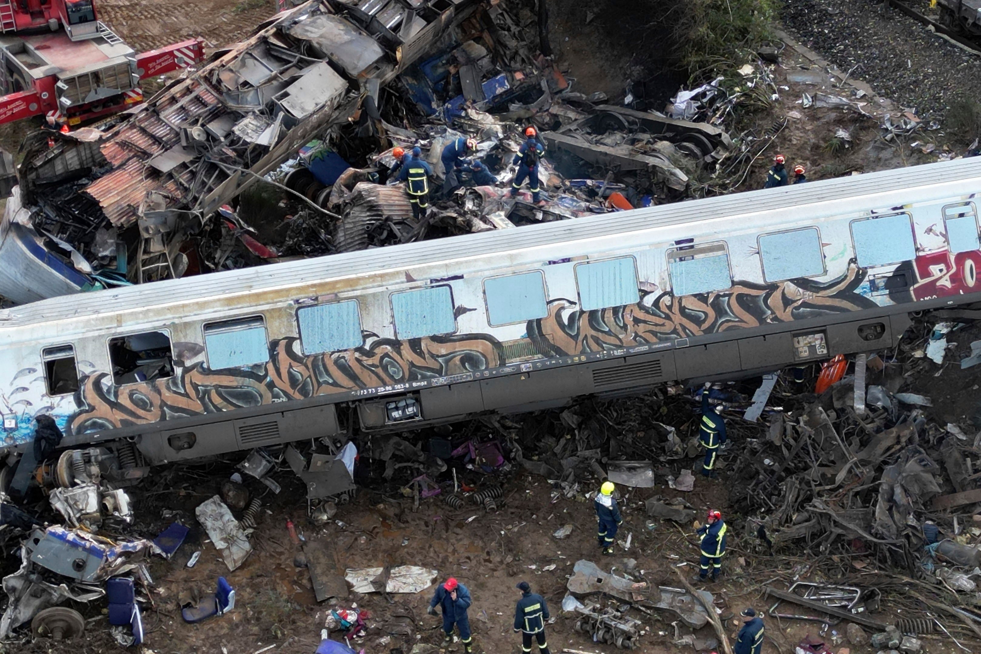 Firefighters and rescuers operate after a collision in Tempe near Larissa city, Greece