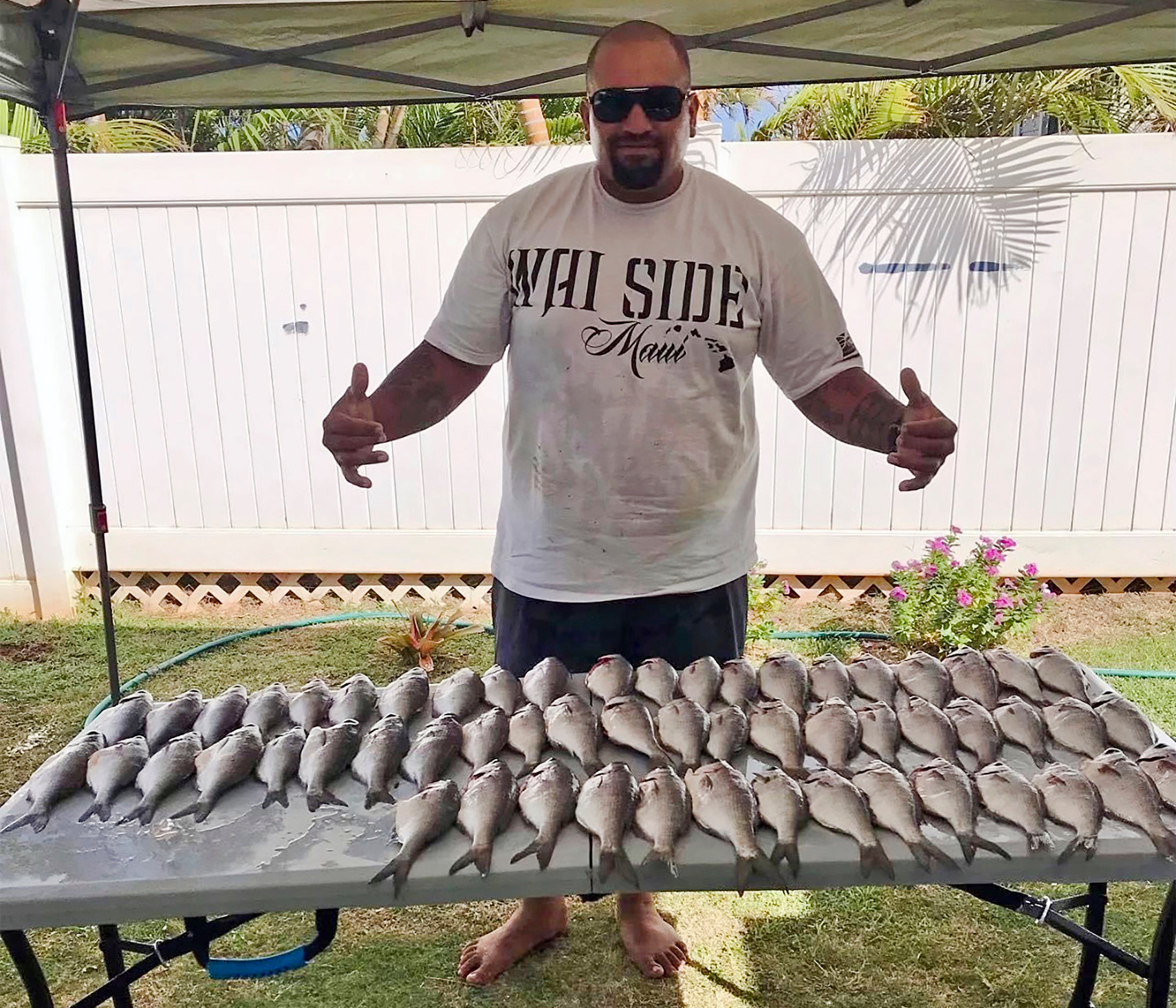 Kaulana Alo-Kaonohi poses with fresh fish caught off Kahakuloa village in Wailuku