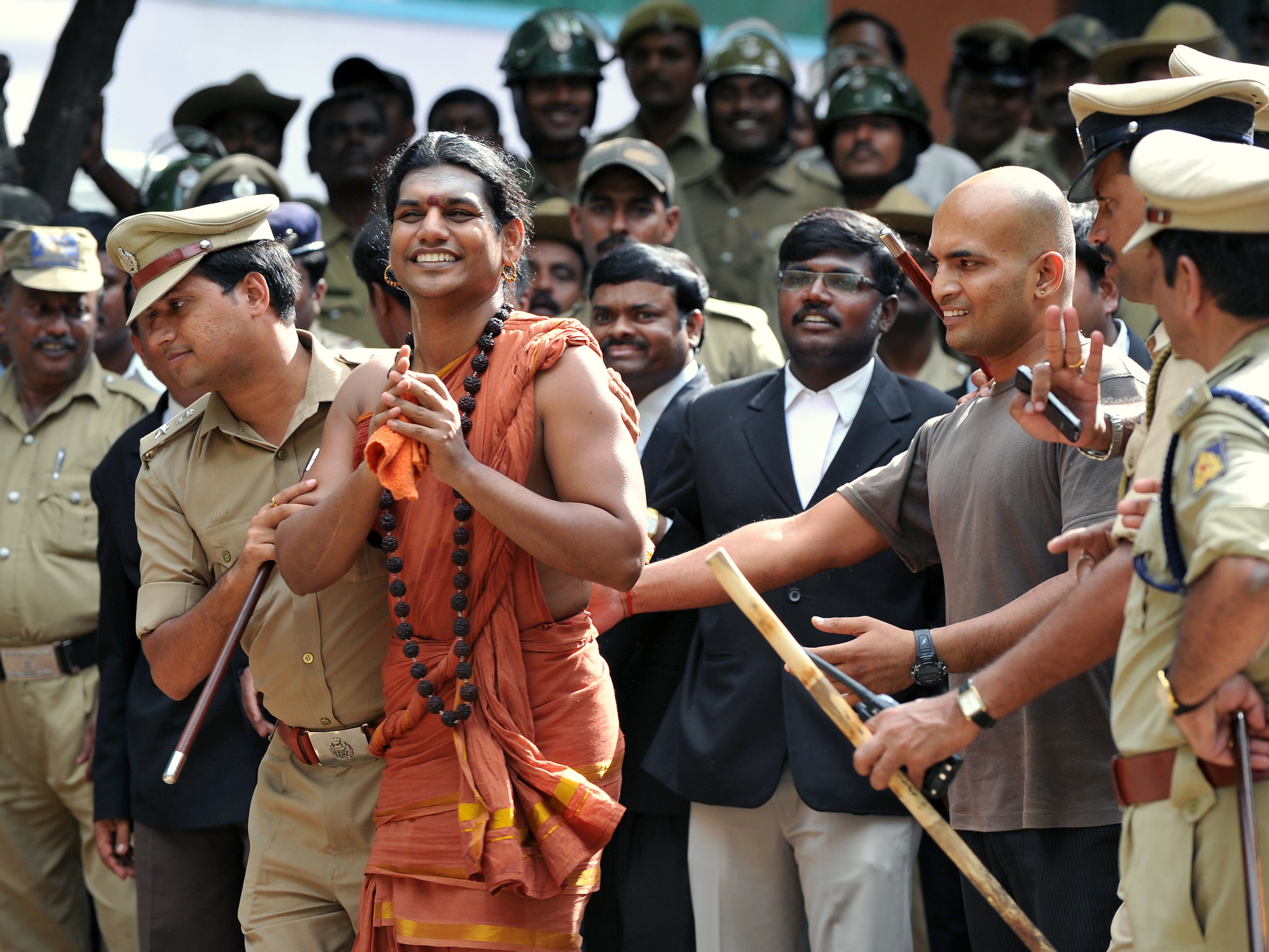 File. Police escort controversial Hindu Godman Swami Nityananda (2nd L) after appearing for his bail plea at the judicial magistrate court at Ramanagar District, some 50 kms from Bangalore, India on 14 June 2012