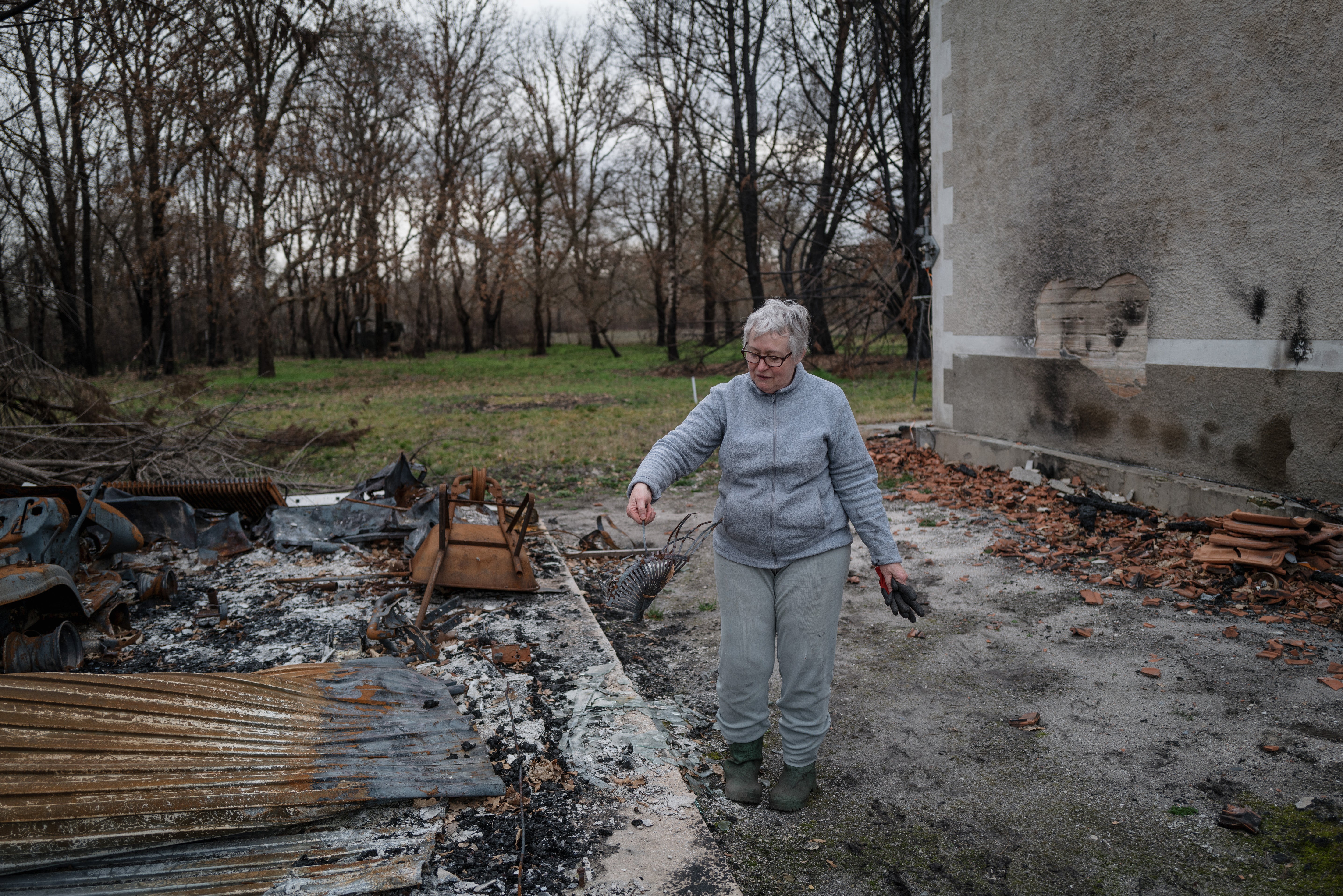 Martine Leveque surveys the charred debris of her brother’s house in southwest France