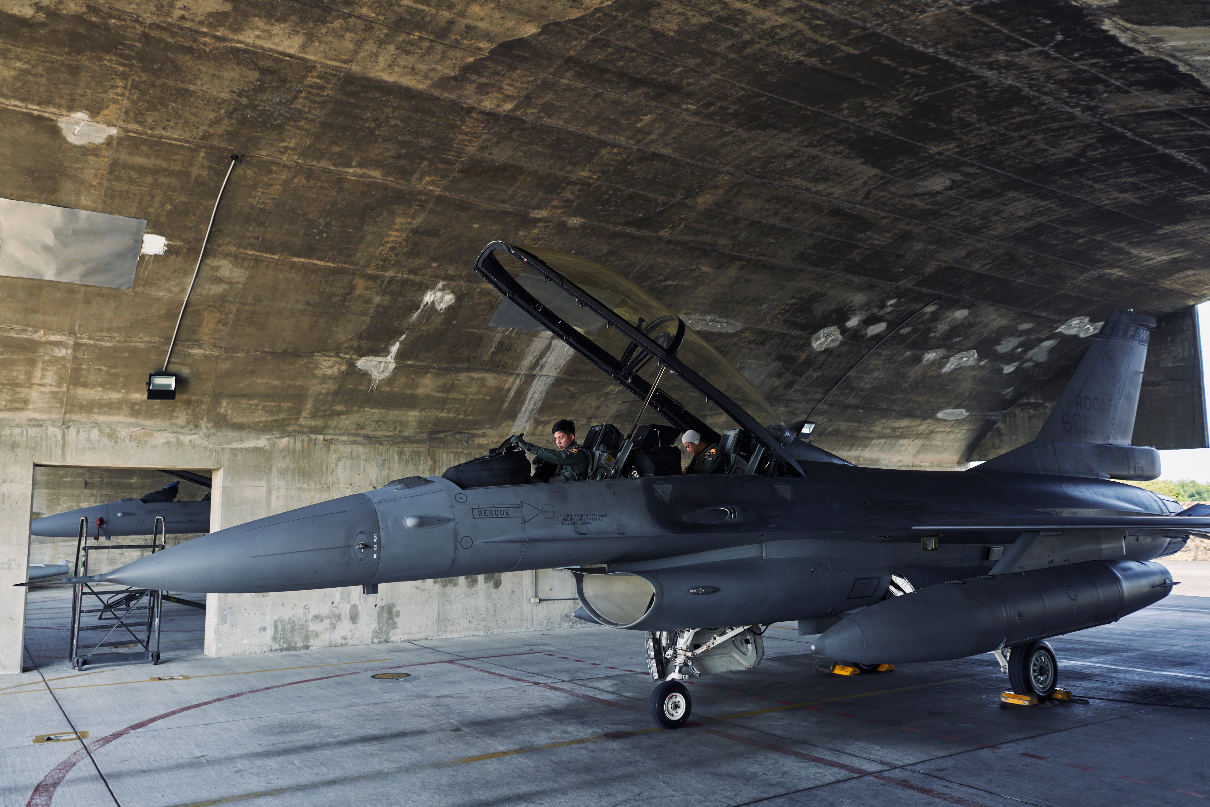 Members of the Taiwanese air force inspect their F-16 jet before taking off for a mission in Chiayi