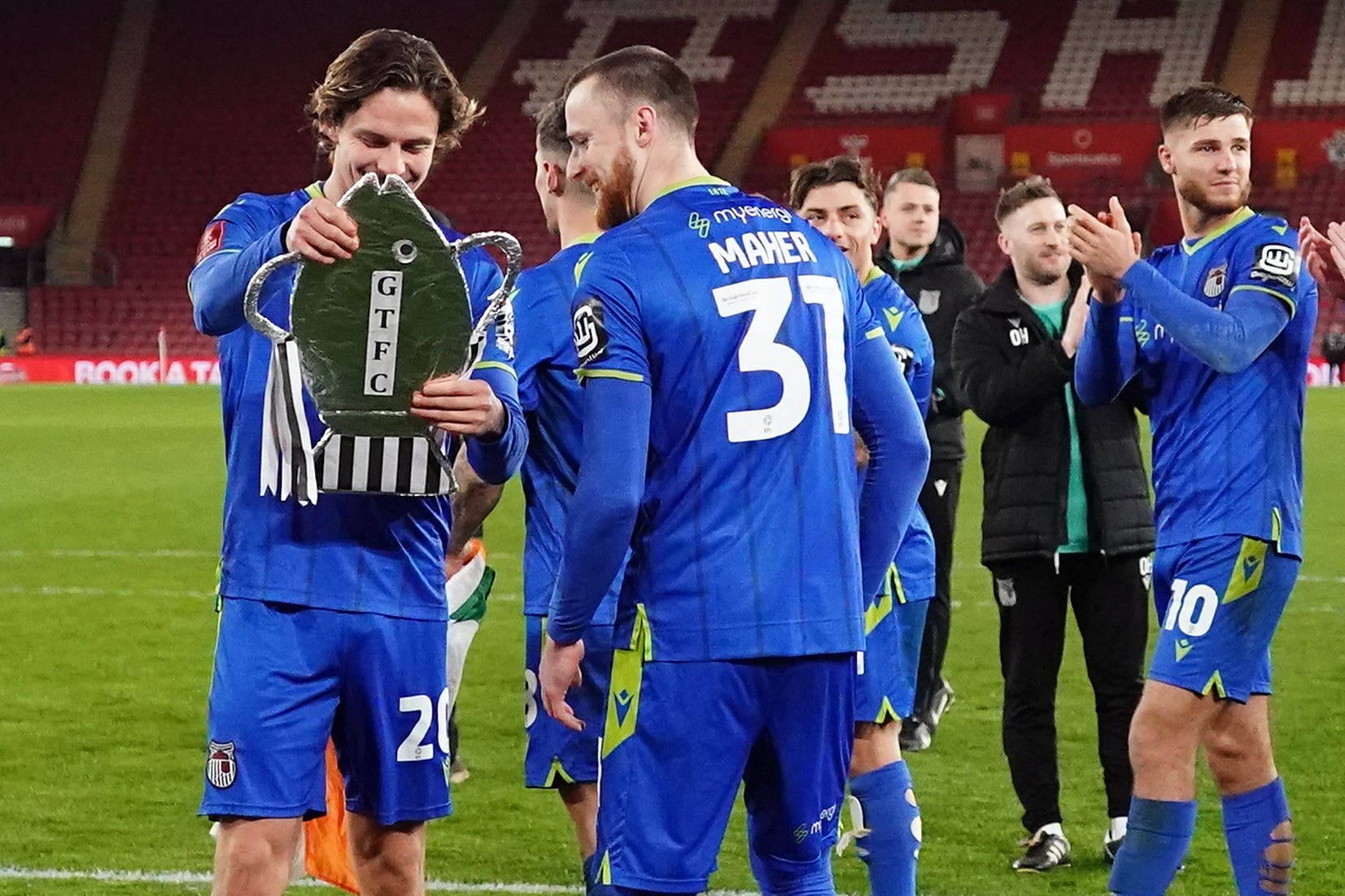 Danilo Orsi, left, holds a replica fish-shaped FA Cup after Grimsby’s win over Southampton (Zac Goodwin/PA)