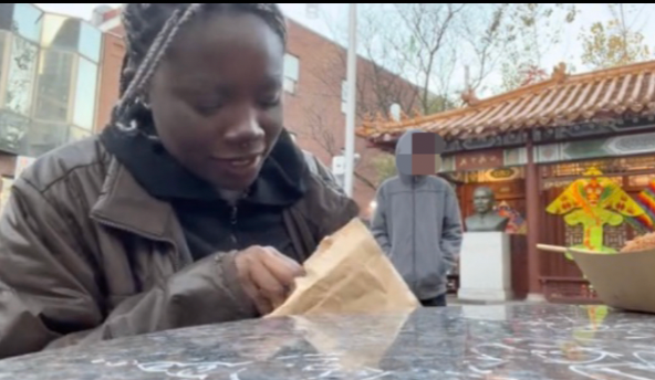 The purported trafficker is seen lurking behind the friend of the woman who posted the video