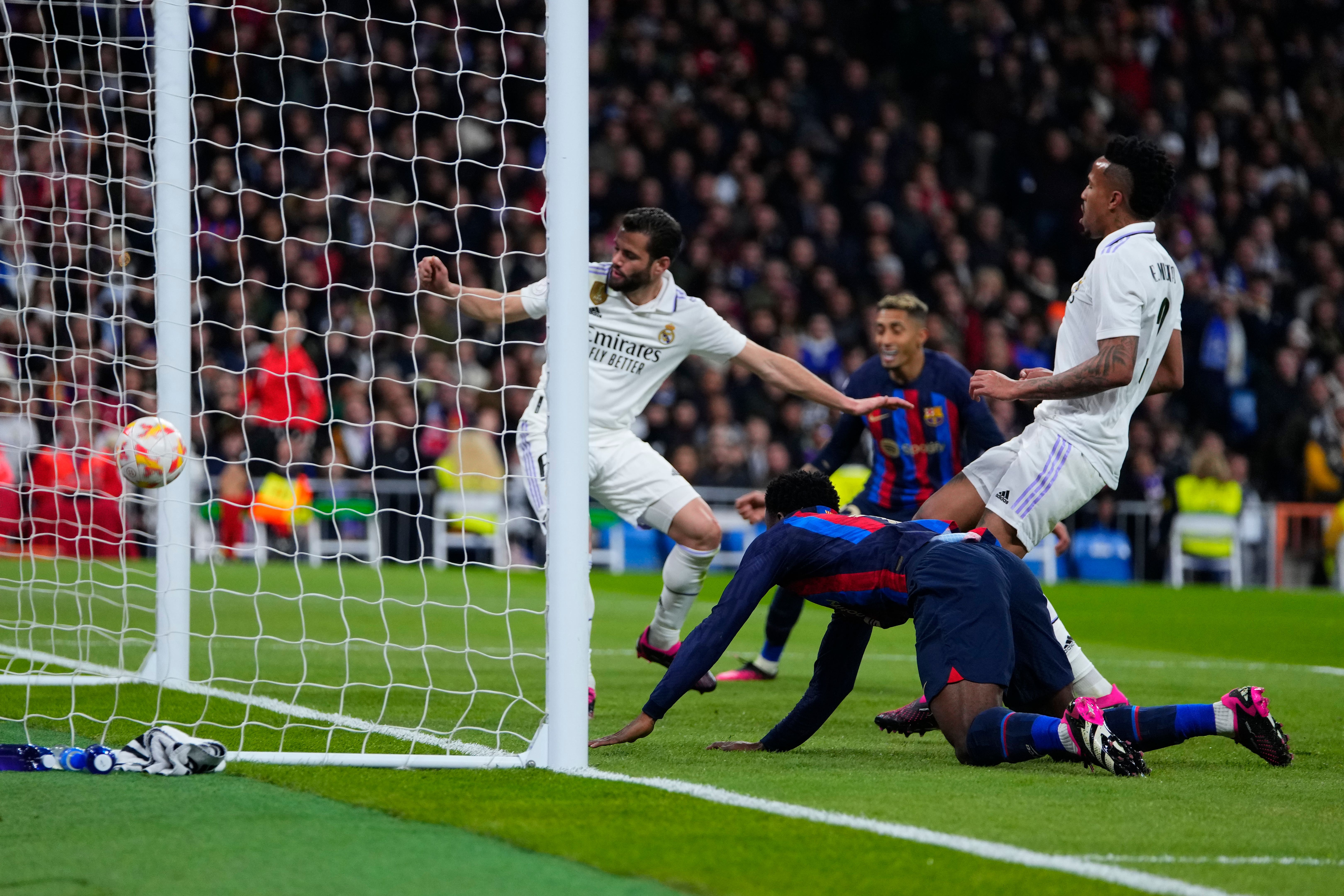 Eder Militao, right, scores an own goal (Manu Fernandez/AP)