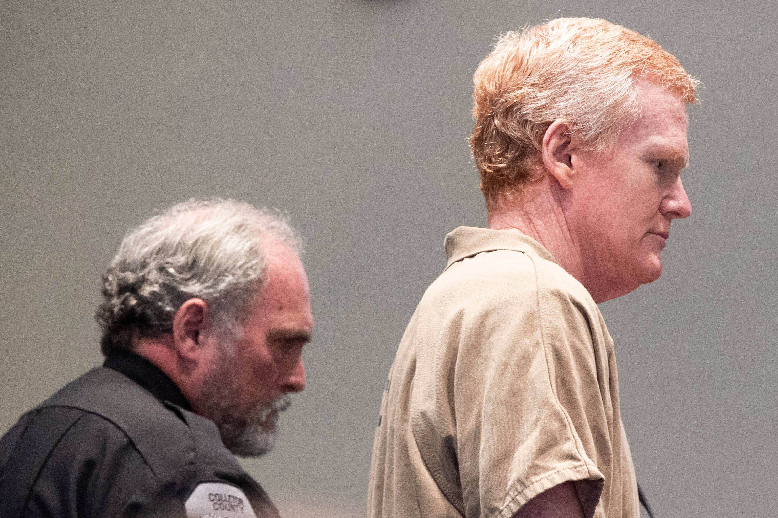 Murdaugh in prison scrubs as he is sentenced to life behind bars