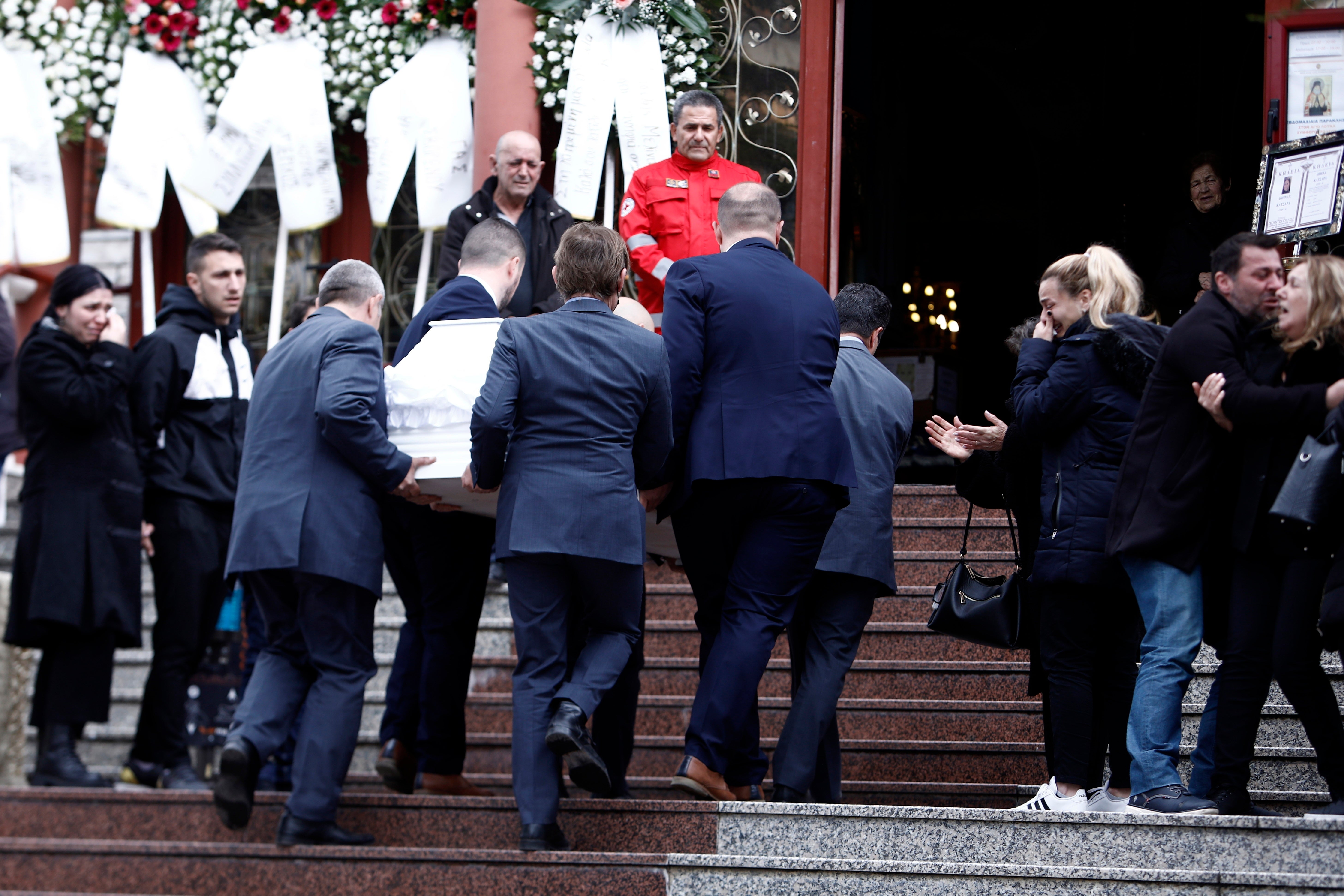 Pallbearers carry the coffin of Athina Katsara, 34, one of the 57 victims of the Greek train crash