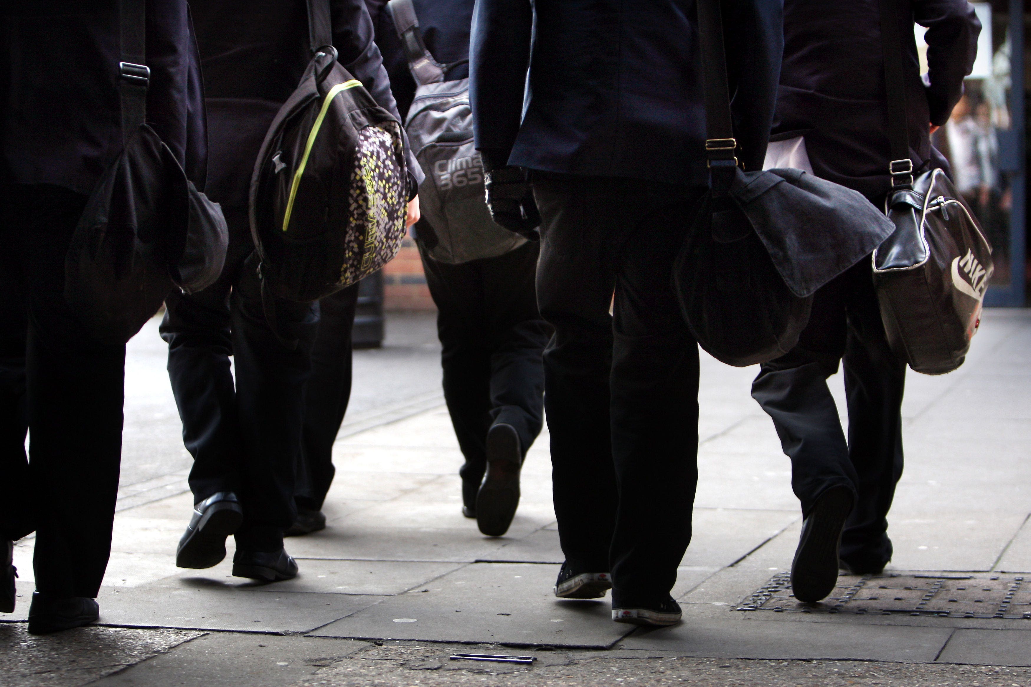 Police have spoken to a pupil who sent death threats to an autistic boy after he caused minor damage to a copy of the Koran (PA)