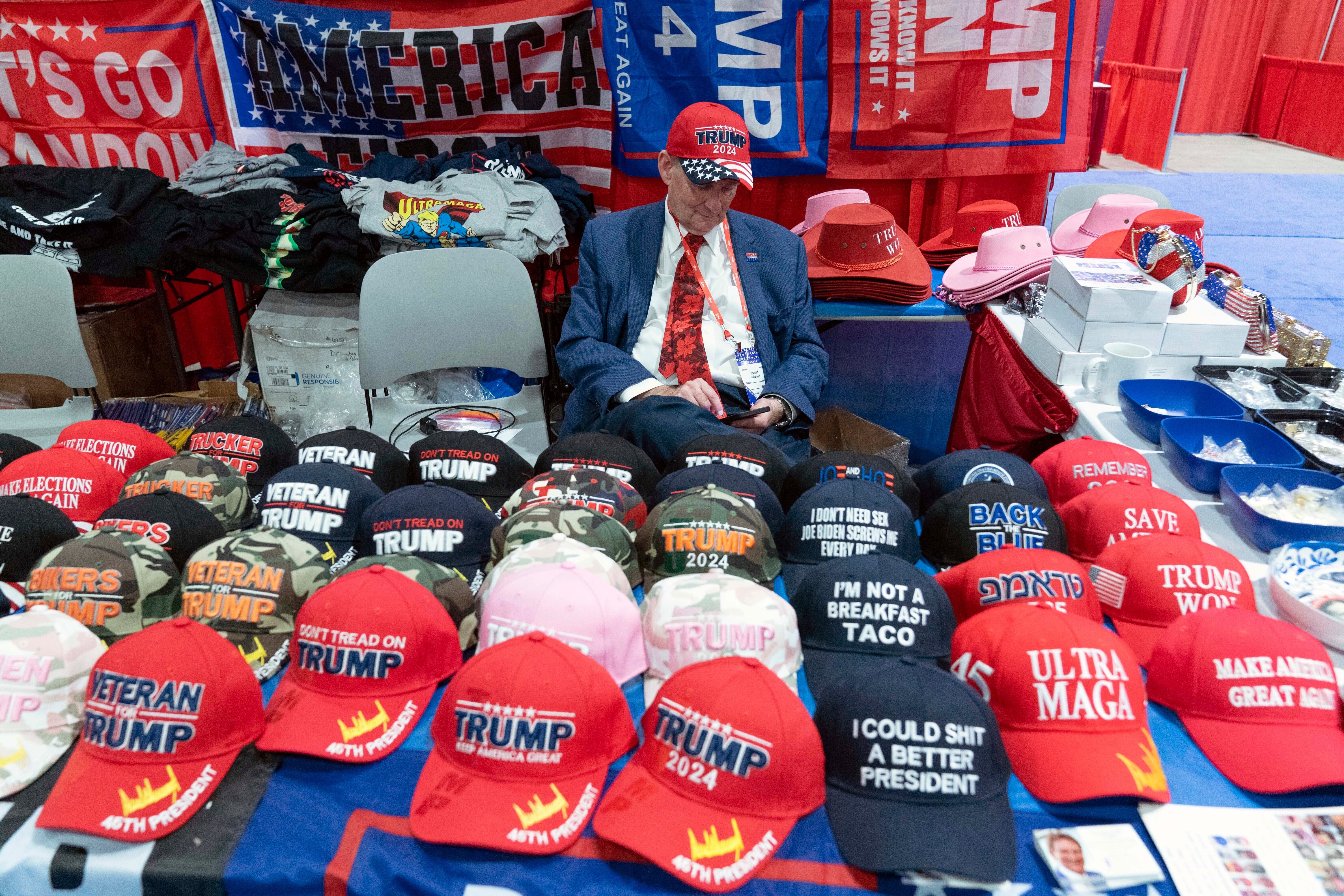 A booth selling hats is seen at the Conservative Political Action Conference, CPAC 2023, cheers during the session, at the National Harbor, in Oxon Hill, Md., Thursday, March 2, 2023. (AP Photo/Jose Luis Magana)