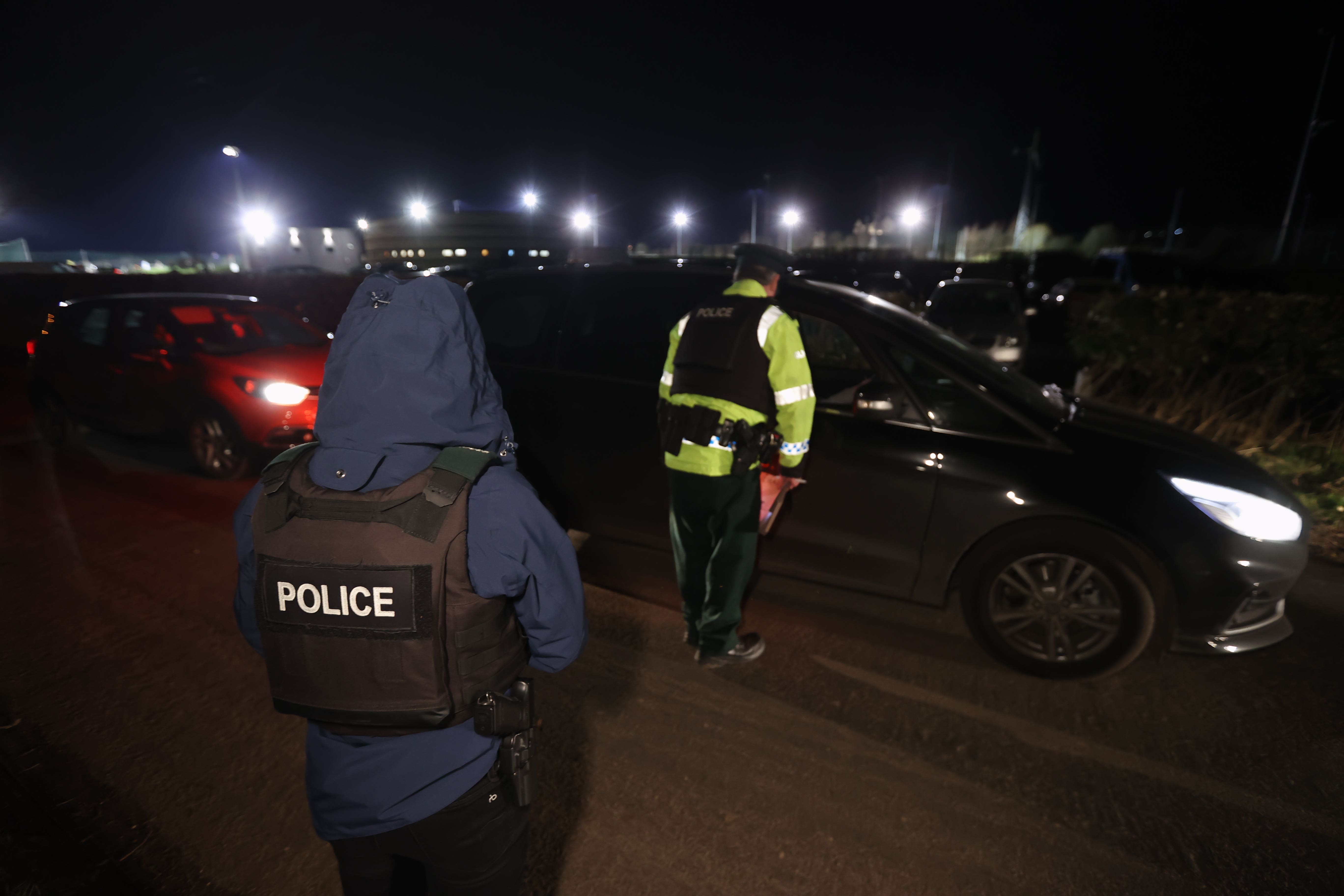 Police officers talk to motorists on Slieveard Park near the sports complex in the Killyclogher Road area of Omagh, Co Tyrone (Liam McBurney/PA)