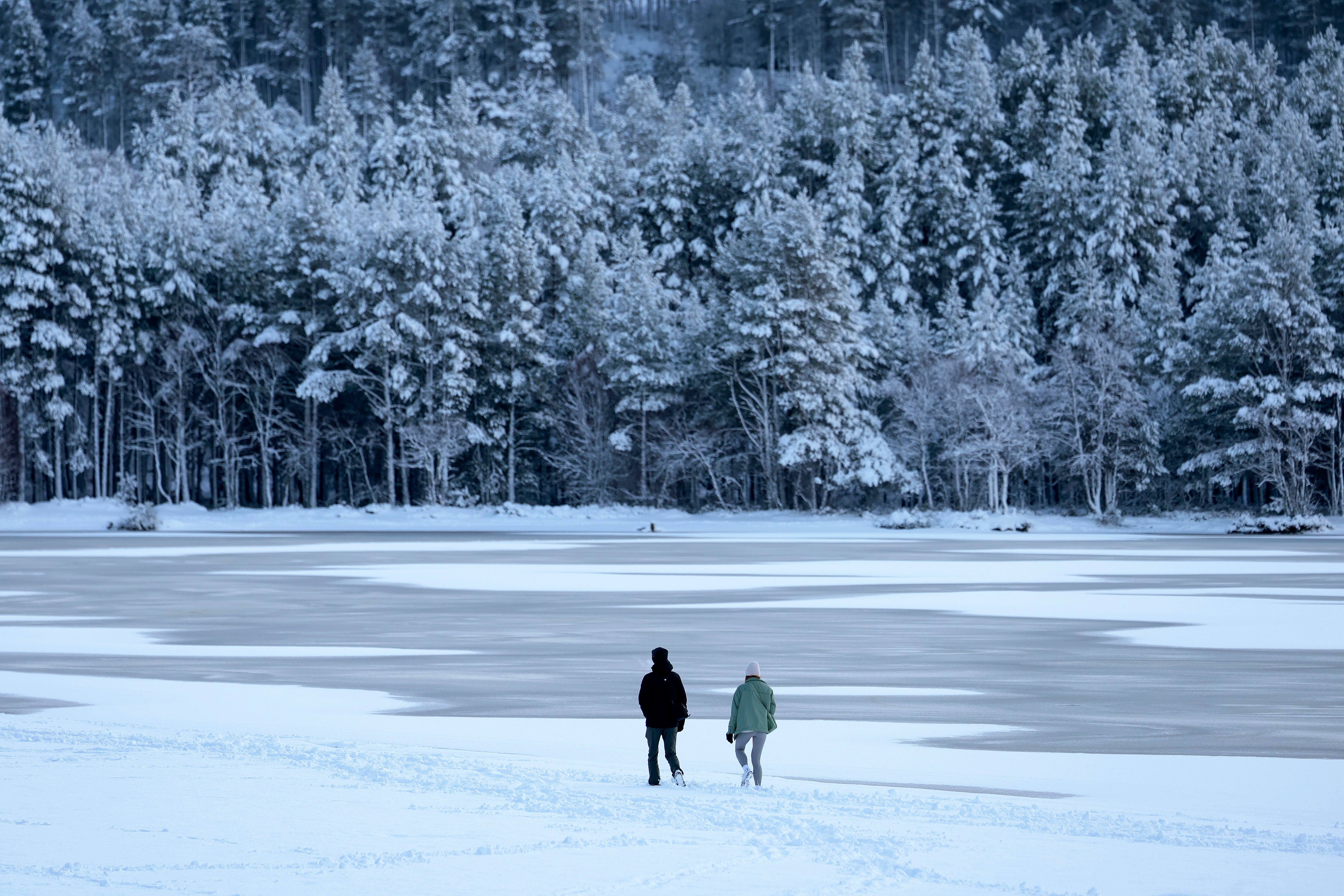 Members of the public are seen at a frozen Loch Morlich on 18 January 2023 in Aviemore, United Kingdom