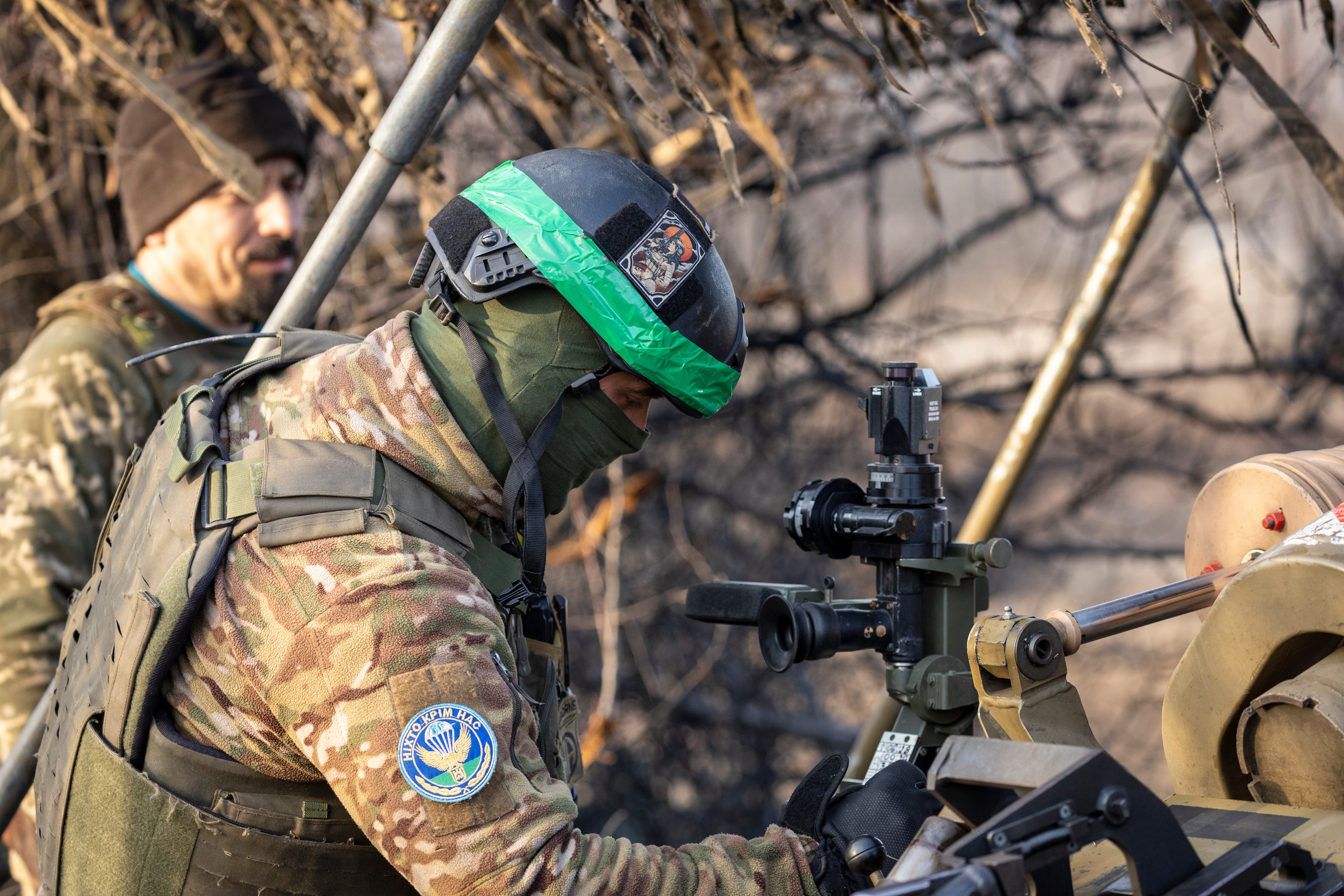 Soldiers from a Ukrainian assault brigade prepare to fire a British made L118 105mm Howitzer on Russian trenches near Bakhmut