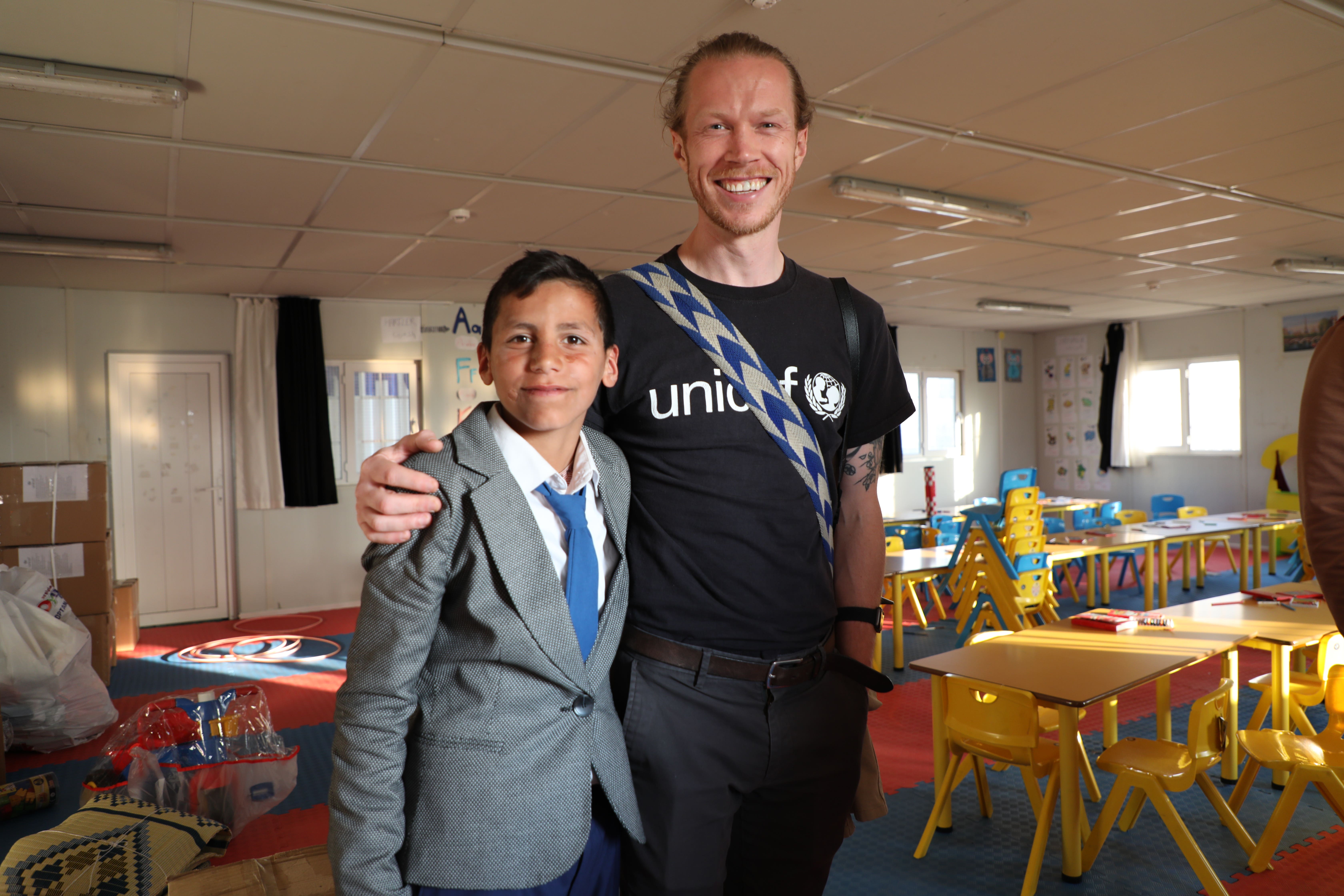 Joe English with a child in Kahramanmaras Temporary Accommodation Centre after twin earthquakes hit south-east Turkey (Unicef/PA)