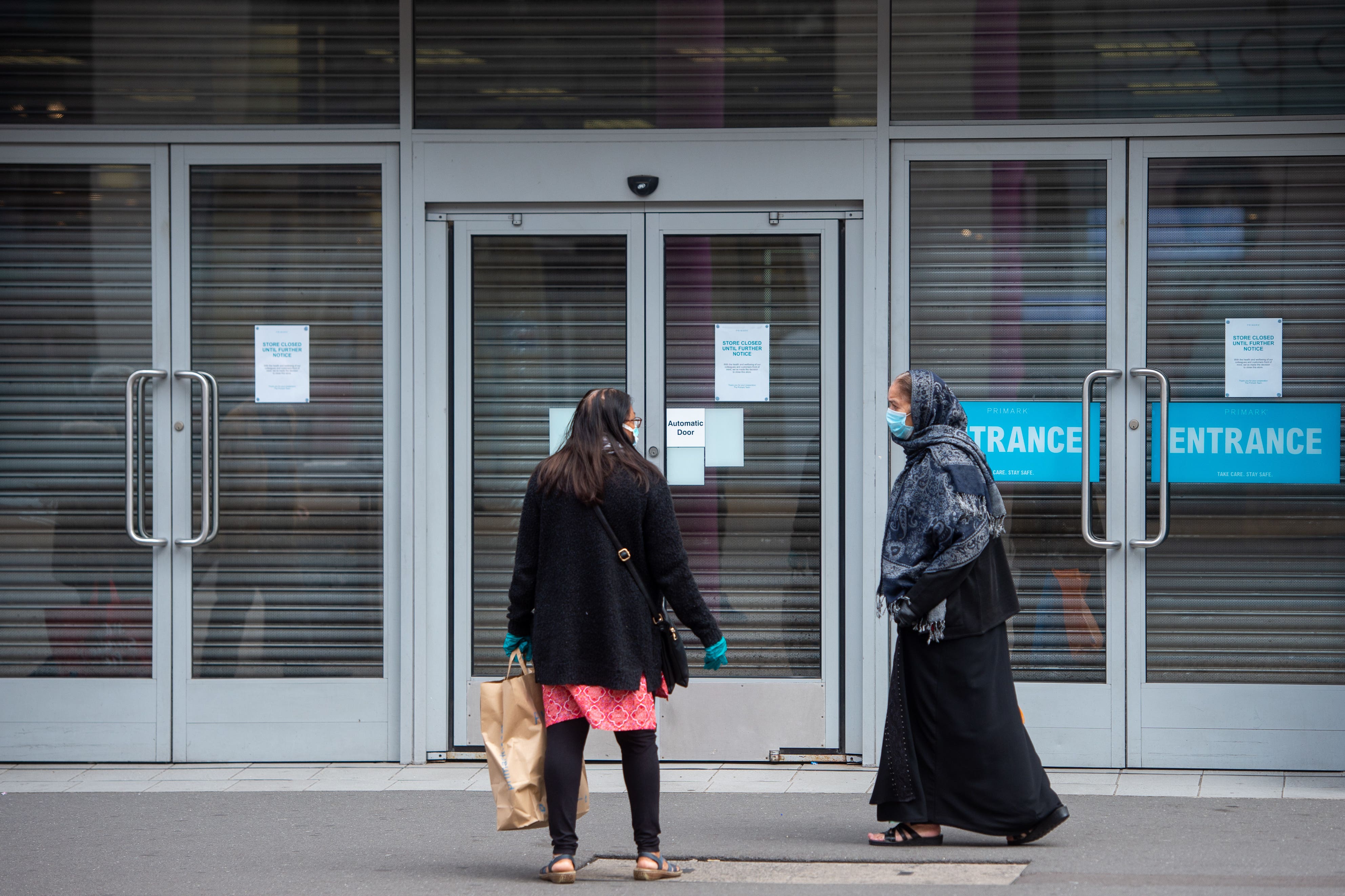 People outside a closed shop in Leicester