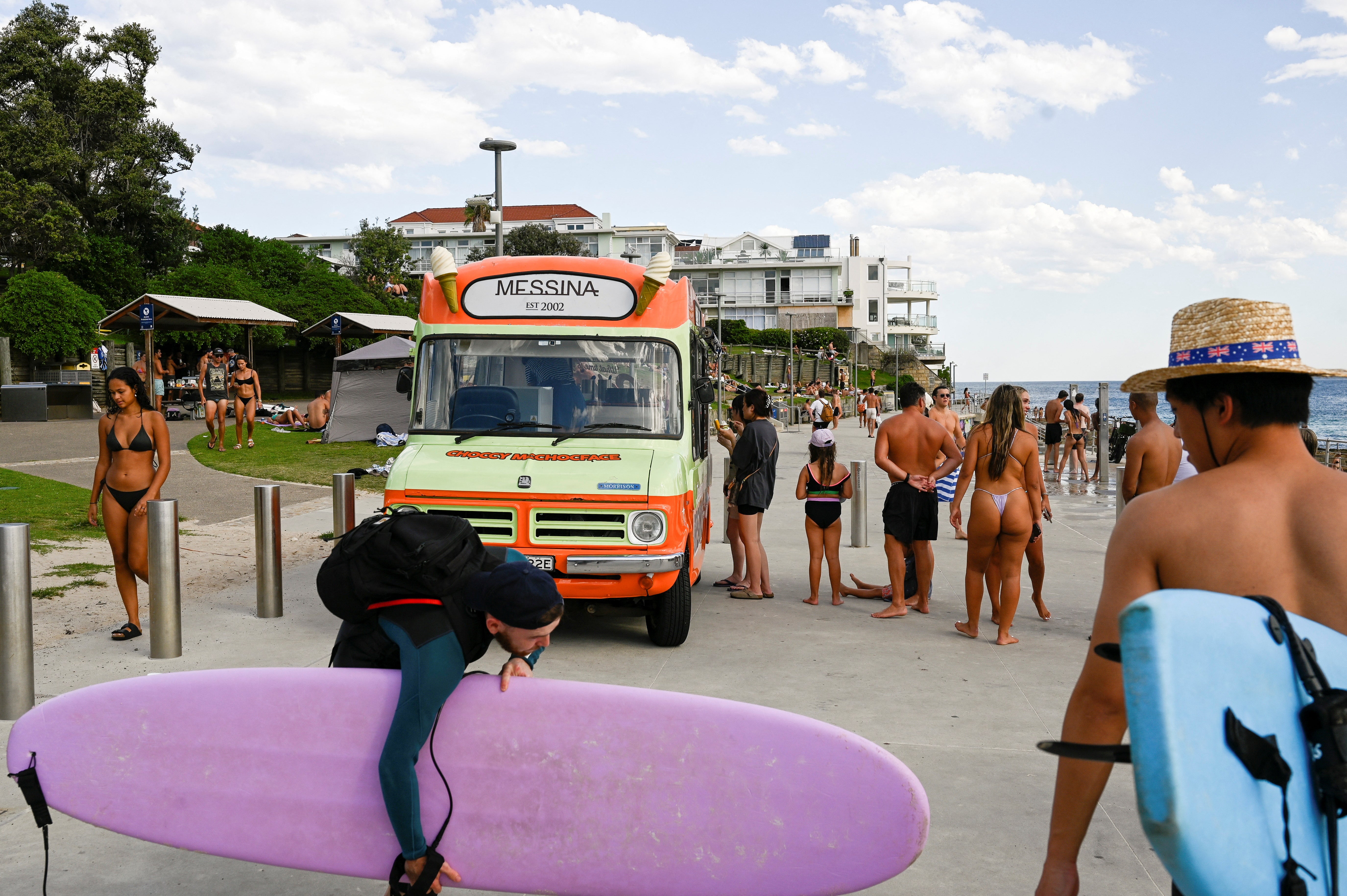 People line up outside an ice cream truck as parts of Australia’s east reached their hottest day in more than two years