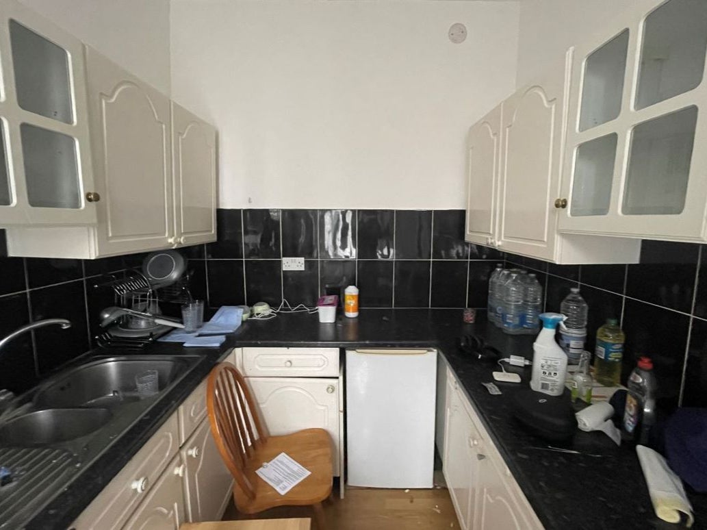 The kitchen in the listing shows bin bags on the surface